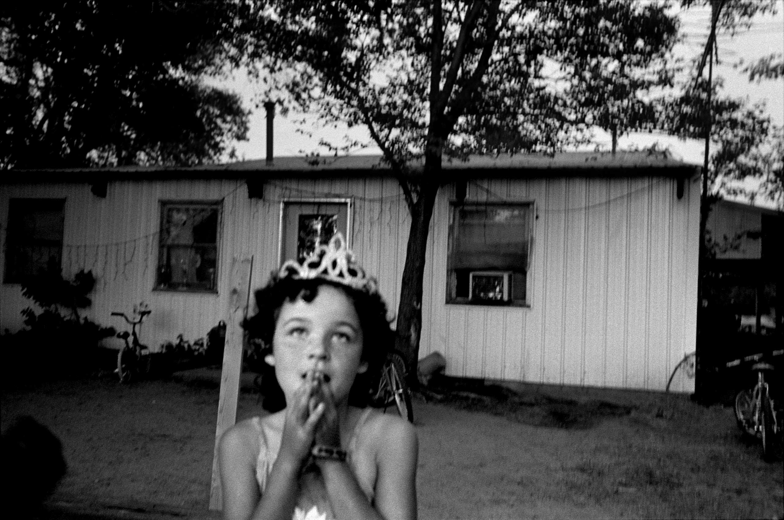 A young girl dreams of becoming a summer festival queen like her older sister, Conesville, Iowa.