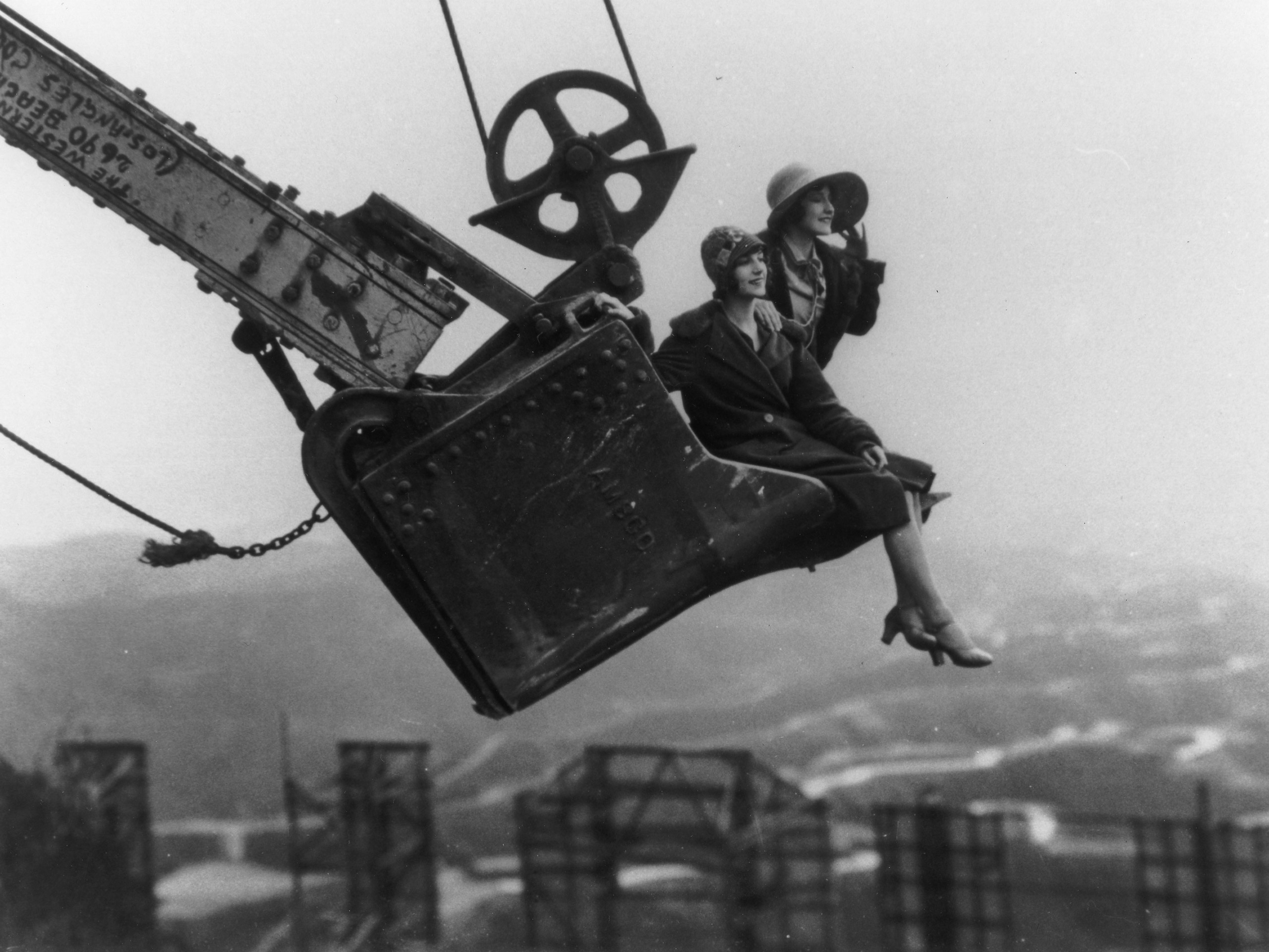 Ladies in a steam shovel bucket, behind the Hollywoodland sign, 1923.