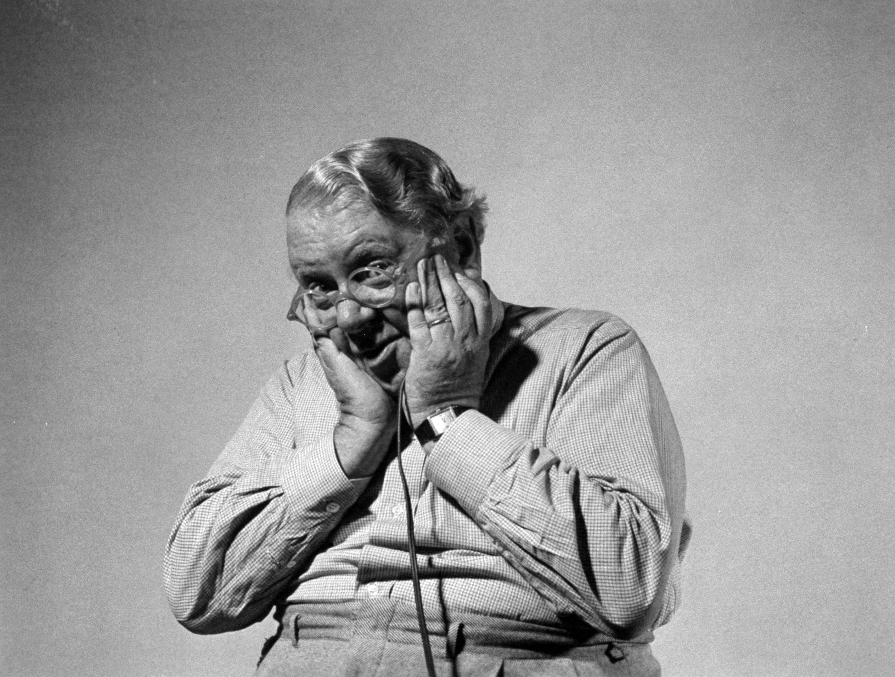 Actor S. Z. Sakall "Cuddles" holding shutter release as he takes his own photograph.