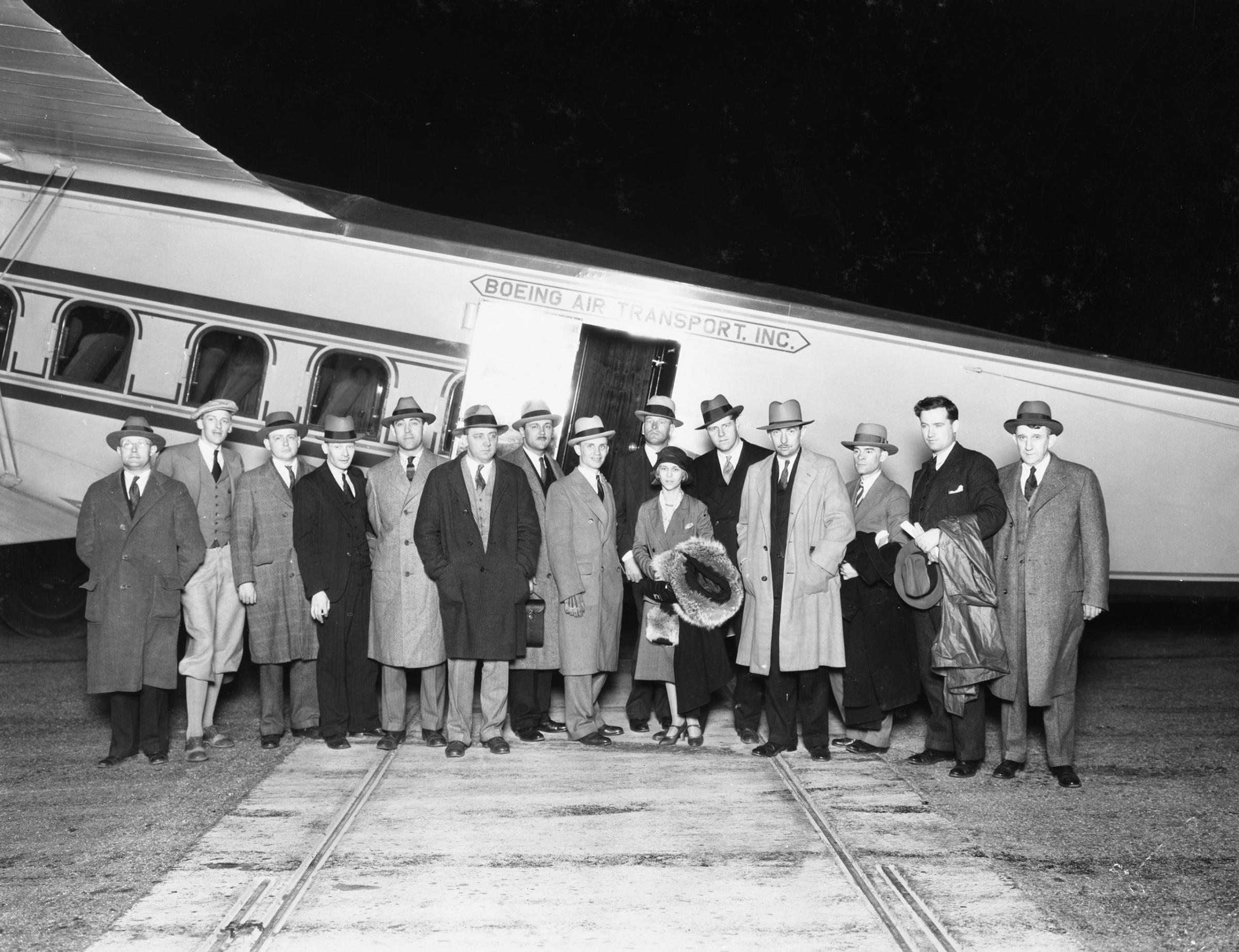 Passengers pose in front of the Model 80, built by Boeing Air Transport.
