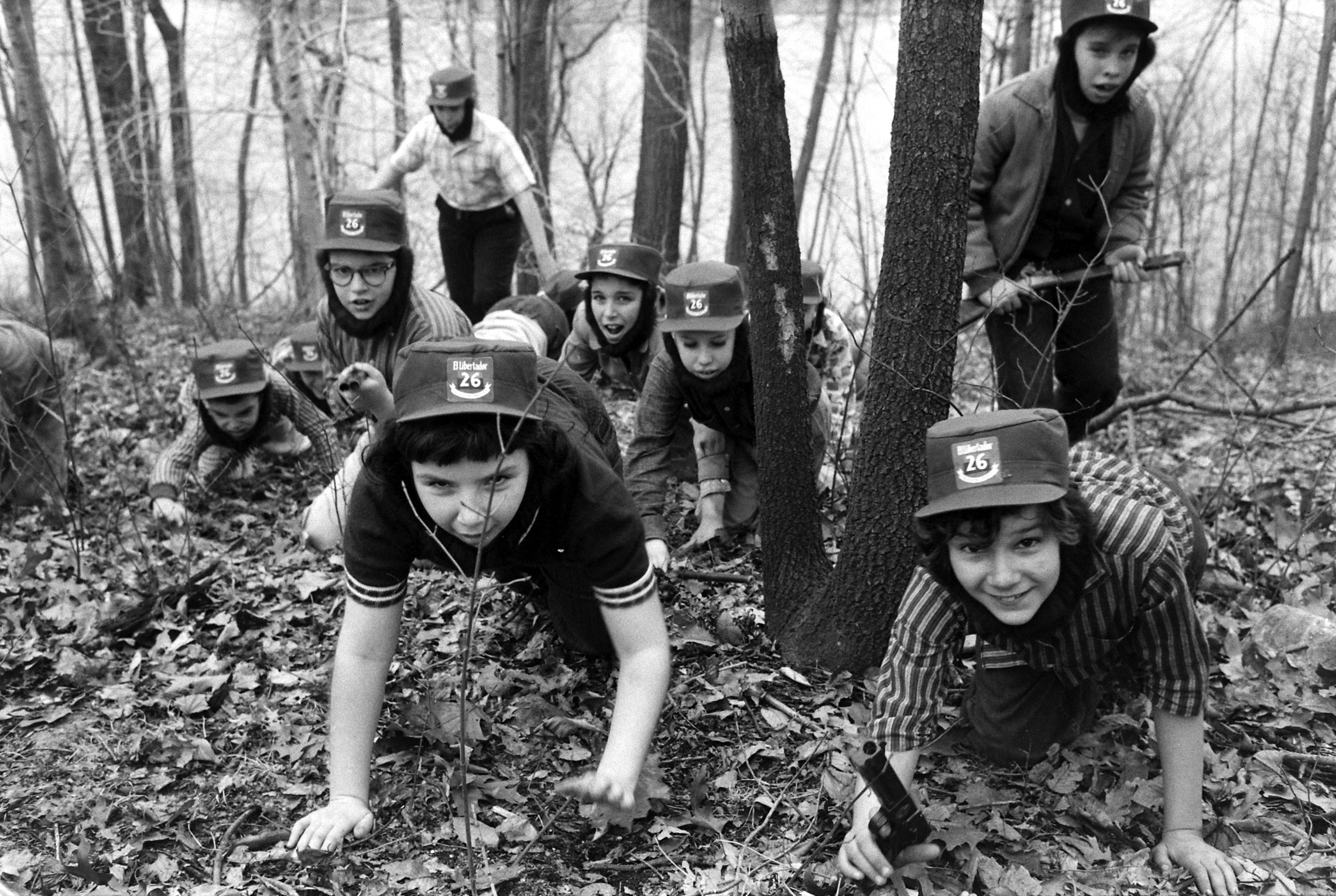 Children wearing Fidel Castro beards and hats, playing in the woods in 1959.