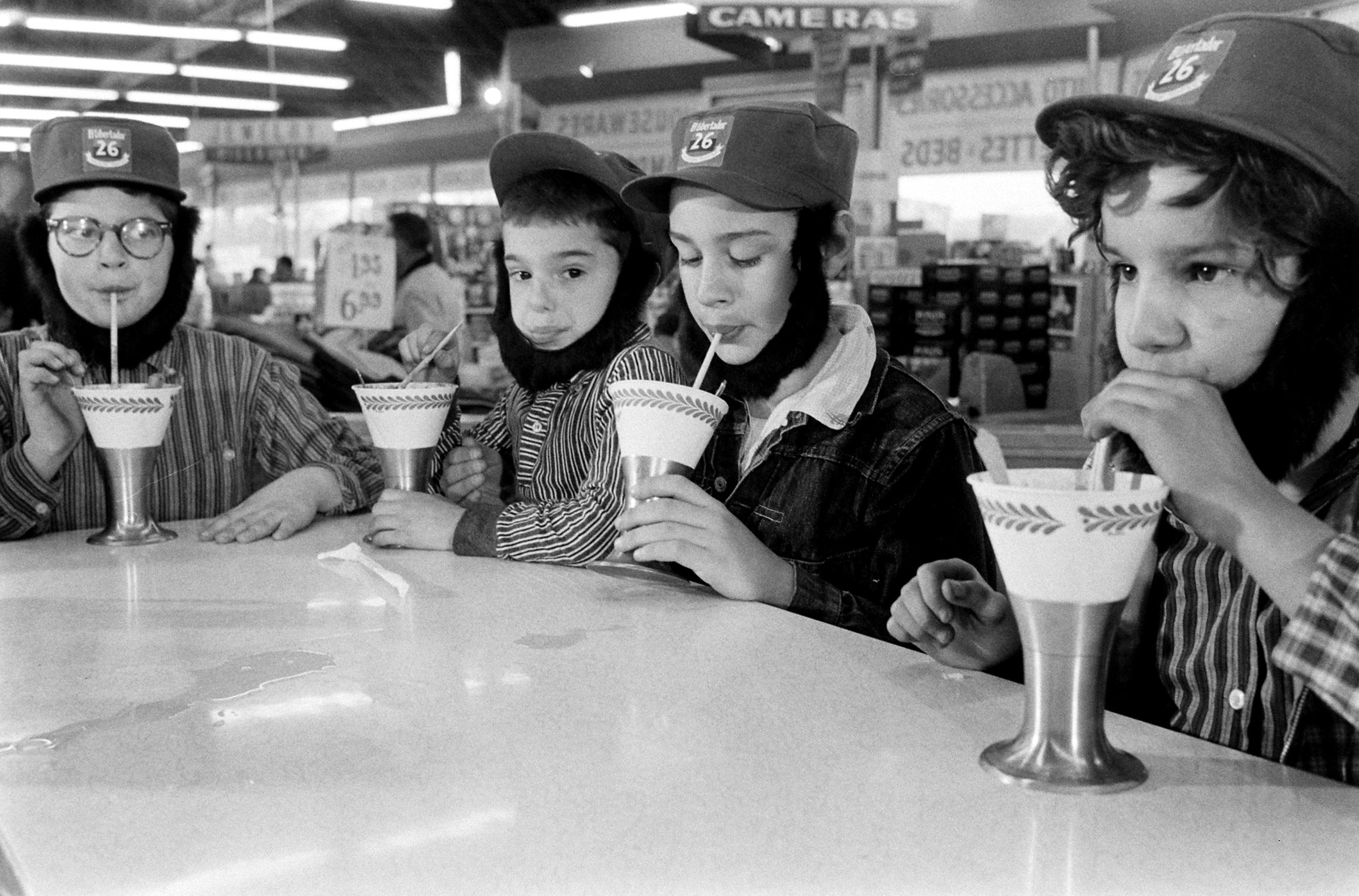 Children wearing Fidel Castro beards and hats, enjoying ice cream in 1959.