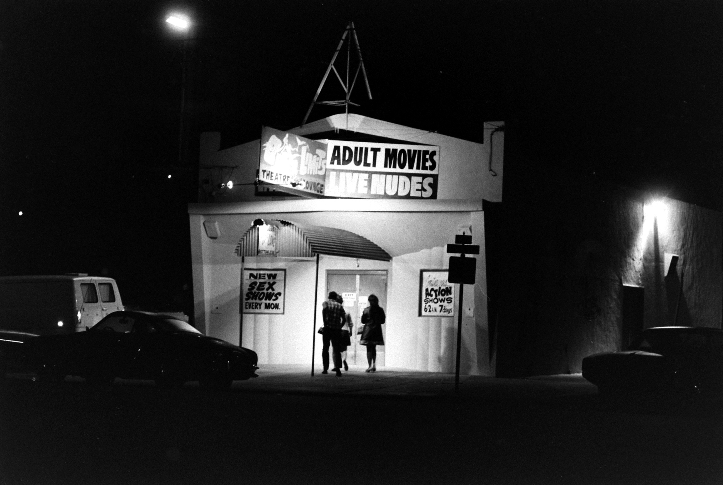 Caption from LIFE. Marquees and bookstore windows mark pornography's wide-open beachheads around the United States.