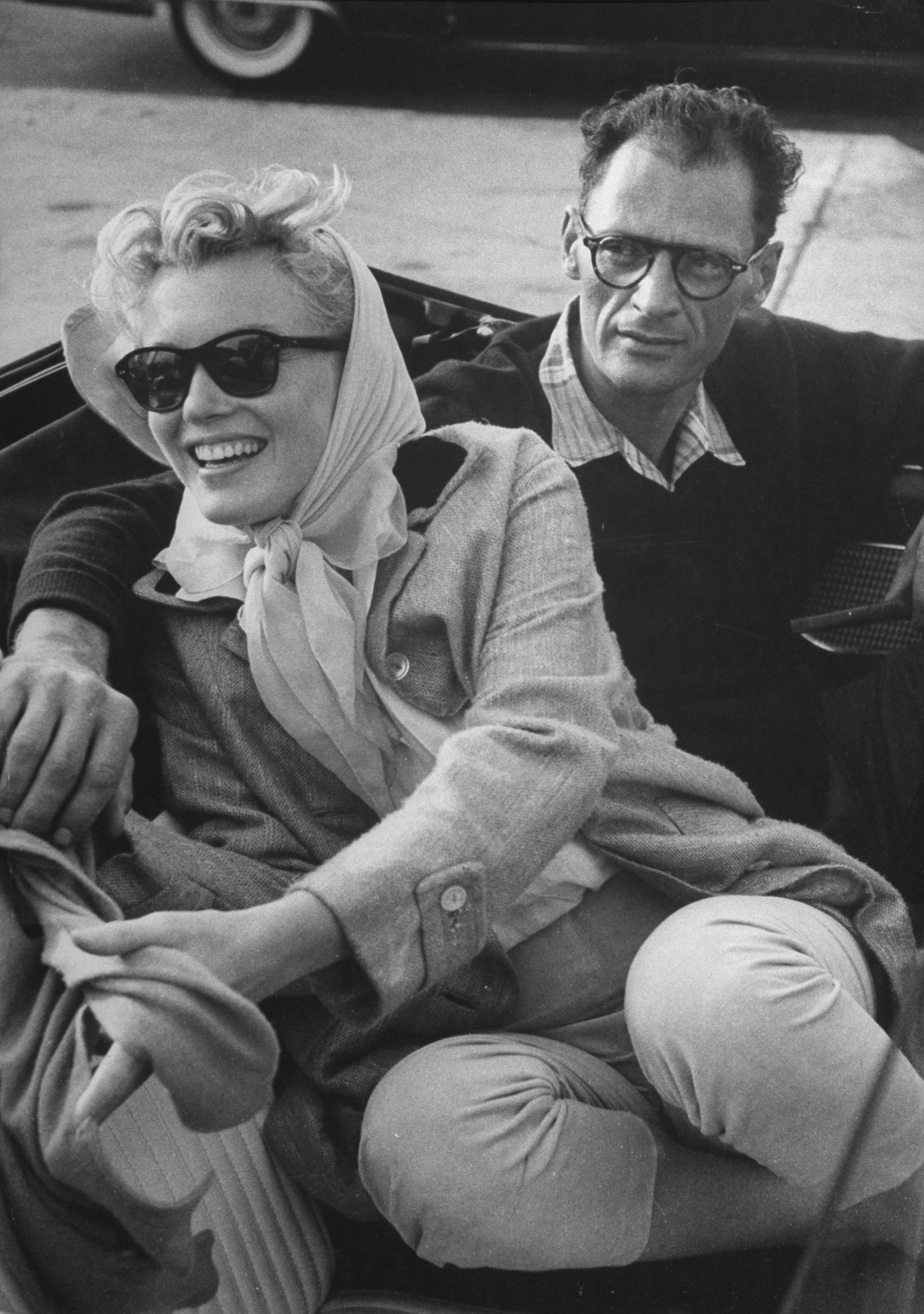 Marilyn Monroe and American playwright Arthur Miller sit in a Thunderbird convertible, 1956.
