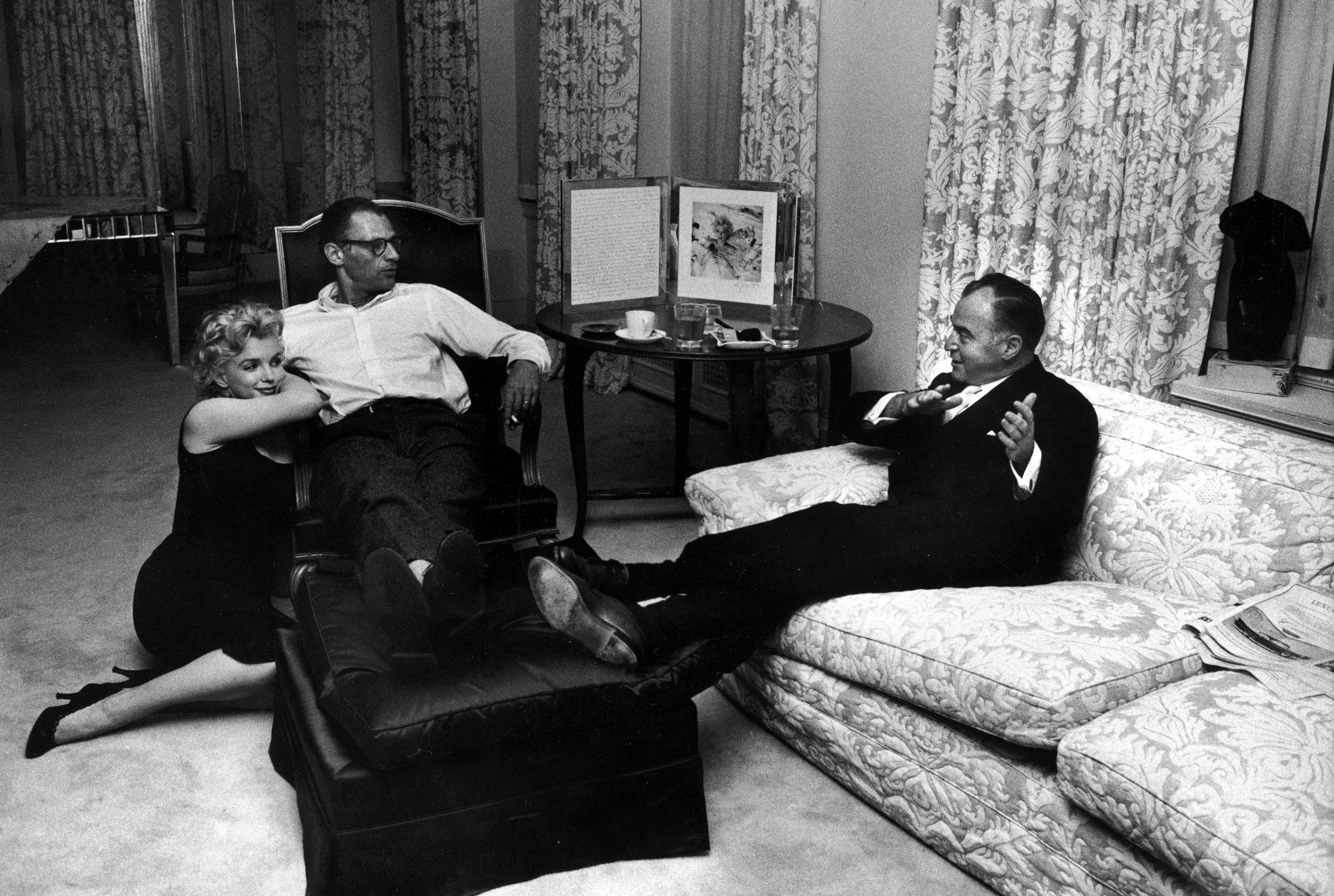 Producer Kermit Bloomgarden (R) visiting with playwright Arthur Miller (C) &amp; his wife, actress Marilyn Monroe, in their apartment, 1958.