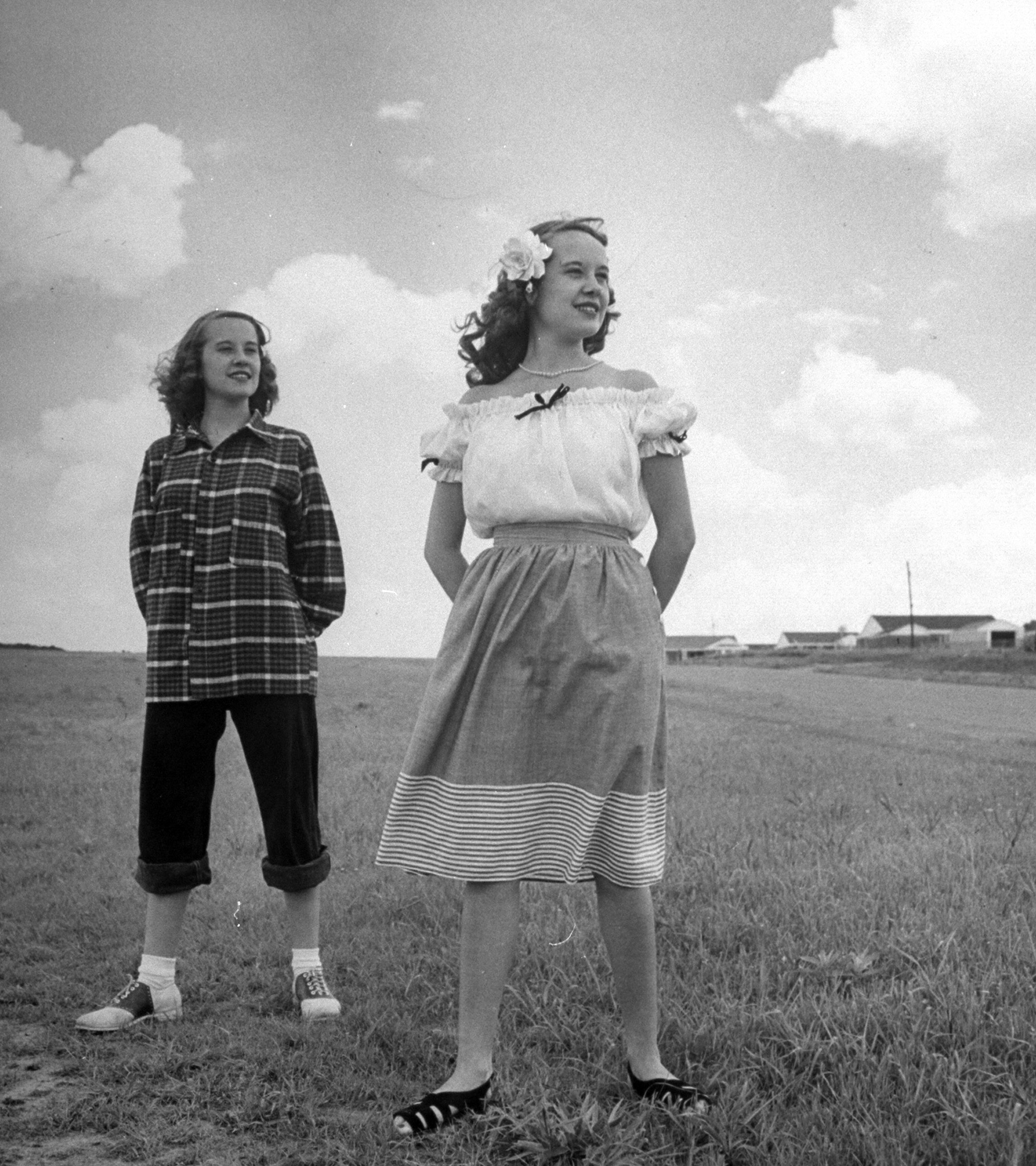 Contrasts in teen-age clothes are shown by Betty Bounds (right), wearing a dainty 1947 outfit, while Barbara poses in sloppy get-up.