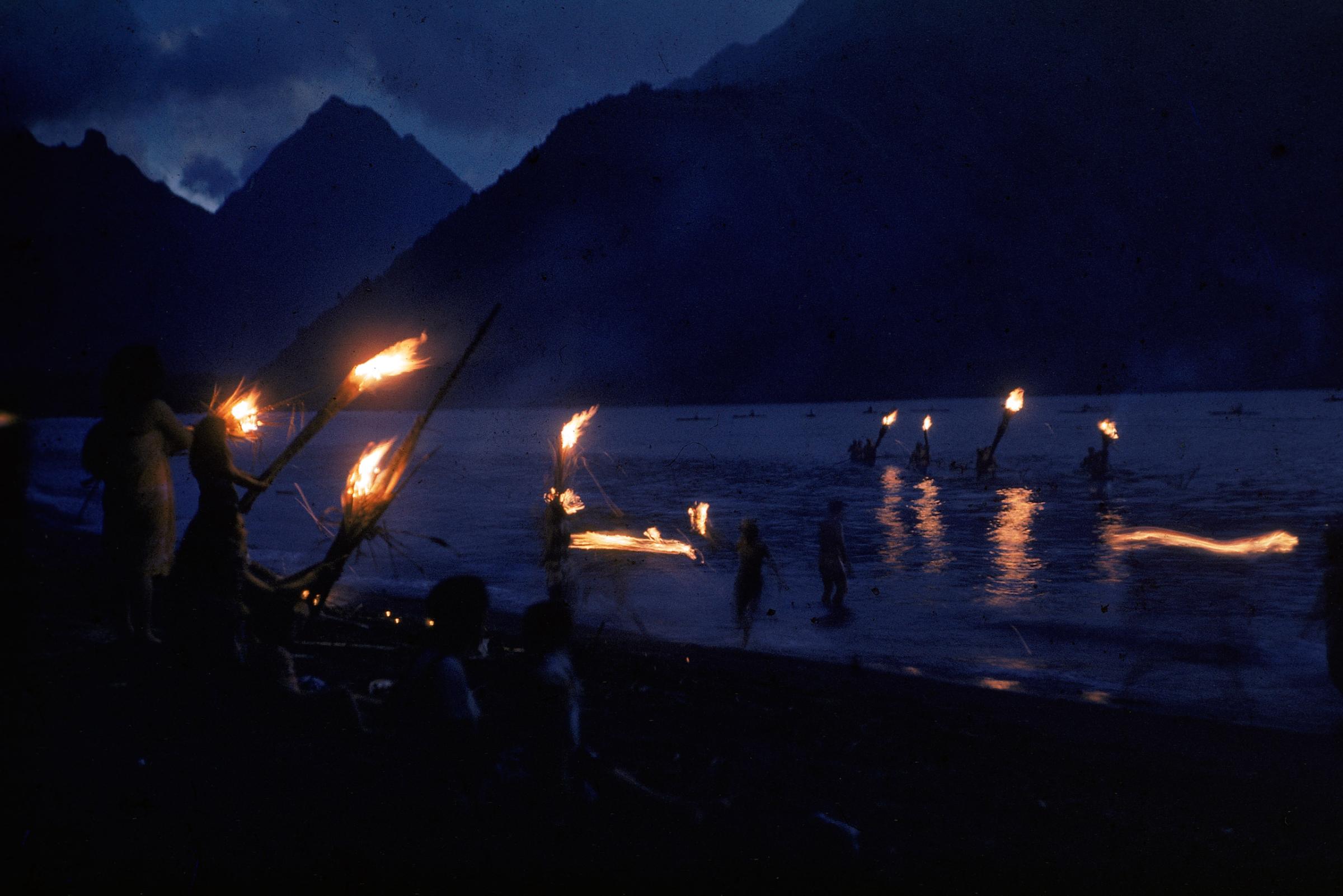 Fiery greeting for canoes in Tahiti.