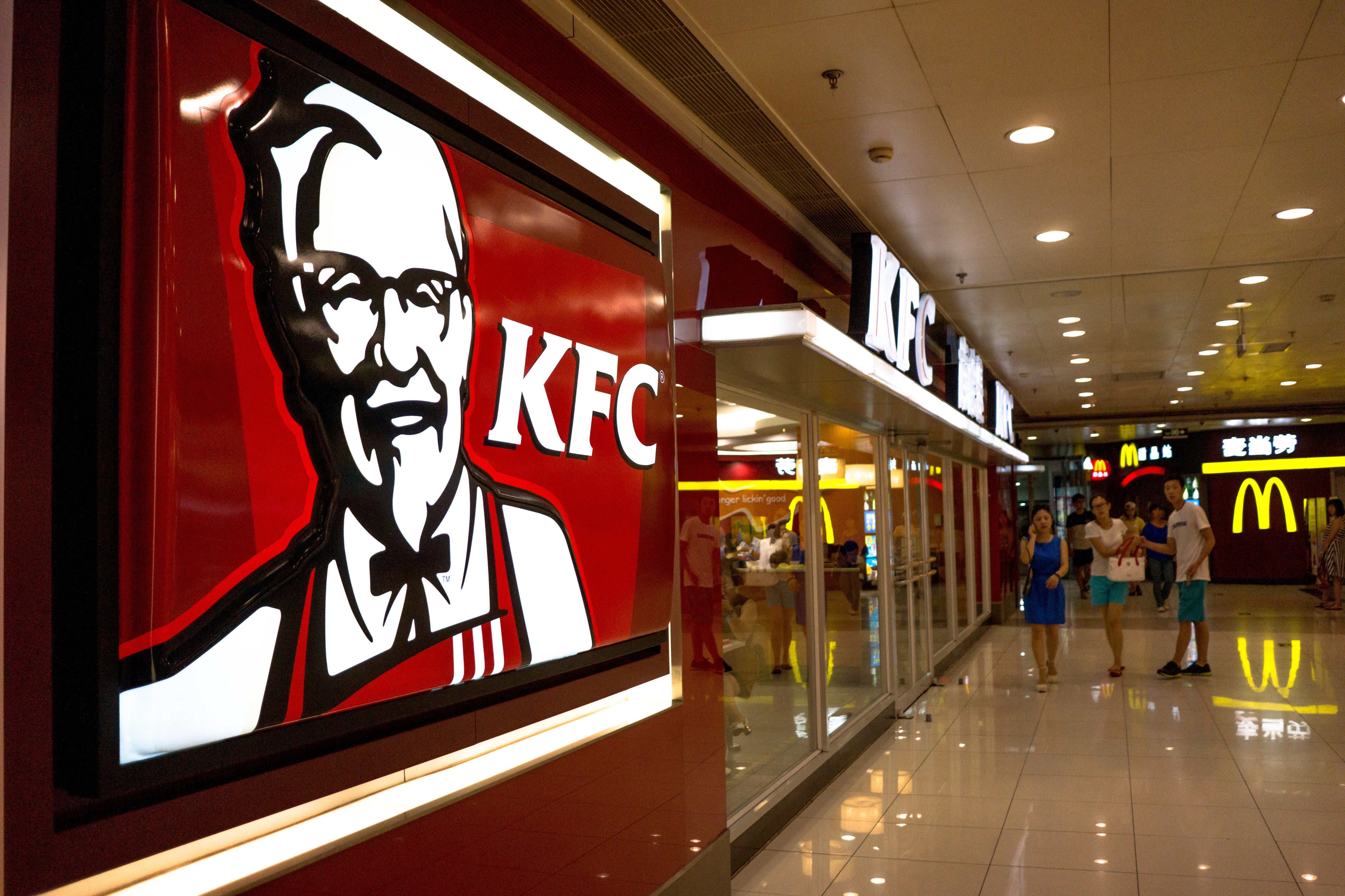 A KFC restaurant in a shopping mall.  KFC, McDonalds,