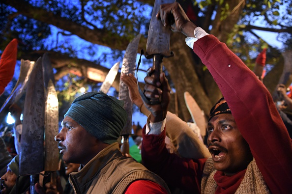 Butchers raise their blades at a temple before the first animal sacrifices by priests are conducted for the Gadhimai festival in the village of Bariyapur, Nepal, on Nov. 28, 2014 (Roberto Schmidt—AFP/Getty Images)