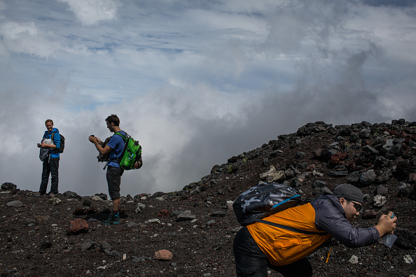 Climbers stop to take photographs along a trail to the summit of Mt Fuji on July 2, 2015 in Fujiyoshida, Japan (Chris McGrath—Getty Images)