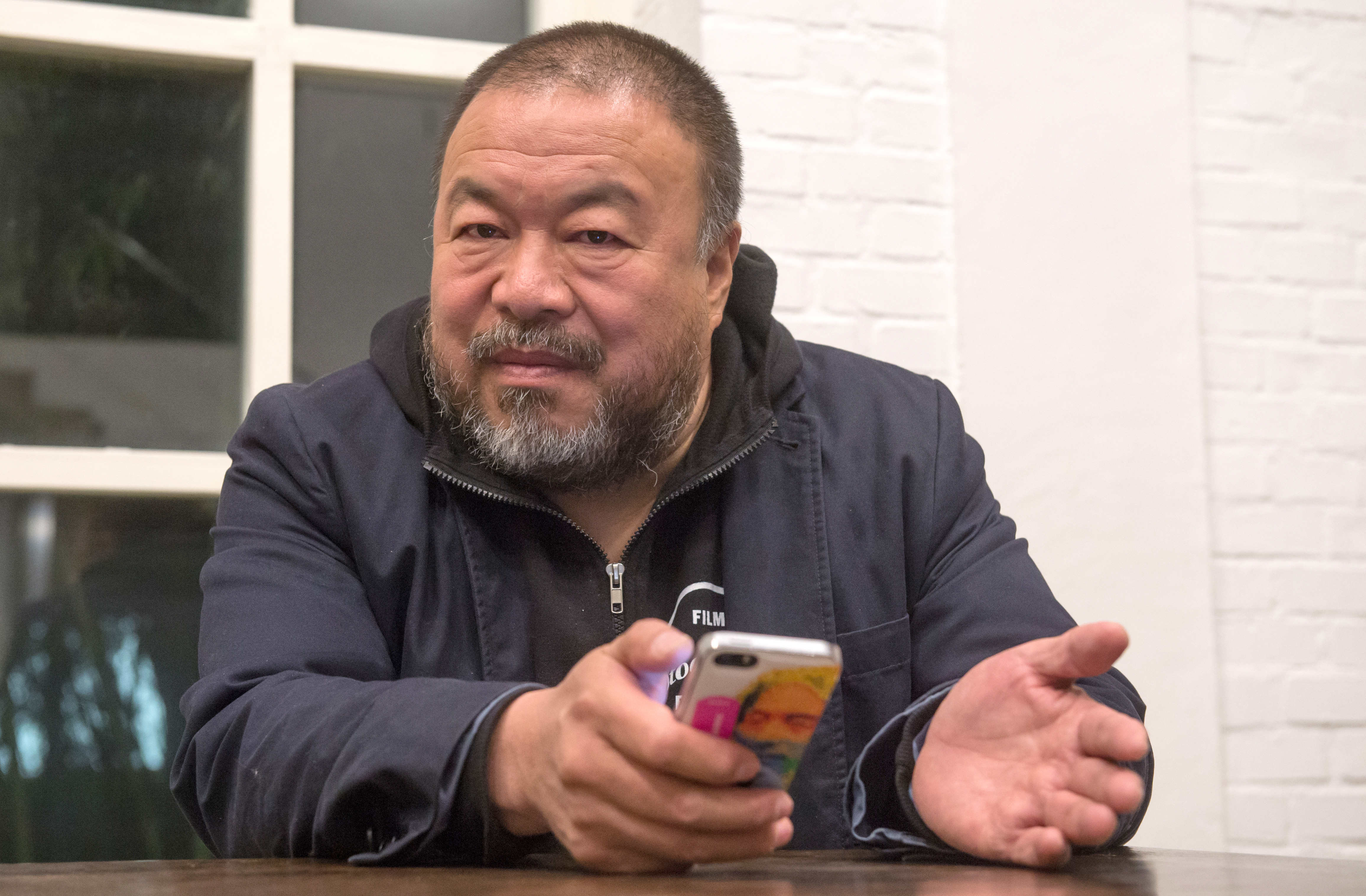 Chinese artist Ai Weiwei in his studio during a visit from  Margarete Bause, Chairman of Alliance '90/The Greens in the Bavarian parliament, in Beijing, China, 23 Nov. 2013 (Peter Kneffel—picture-alliance/dpa/AP Images)