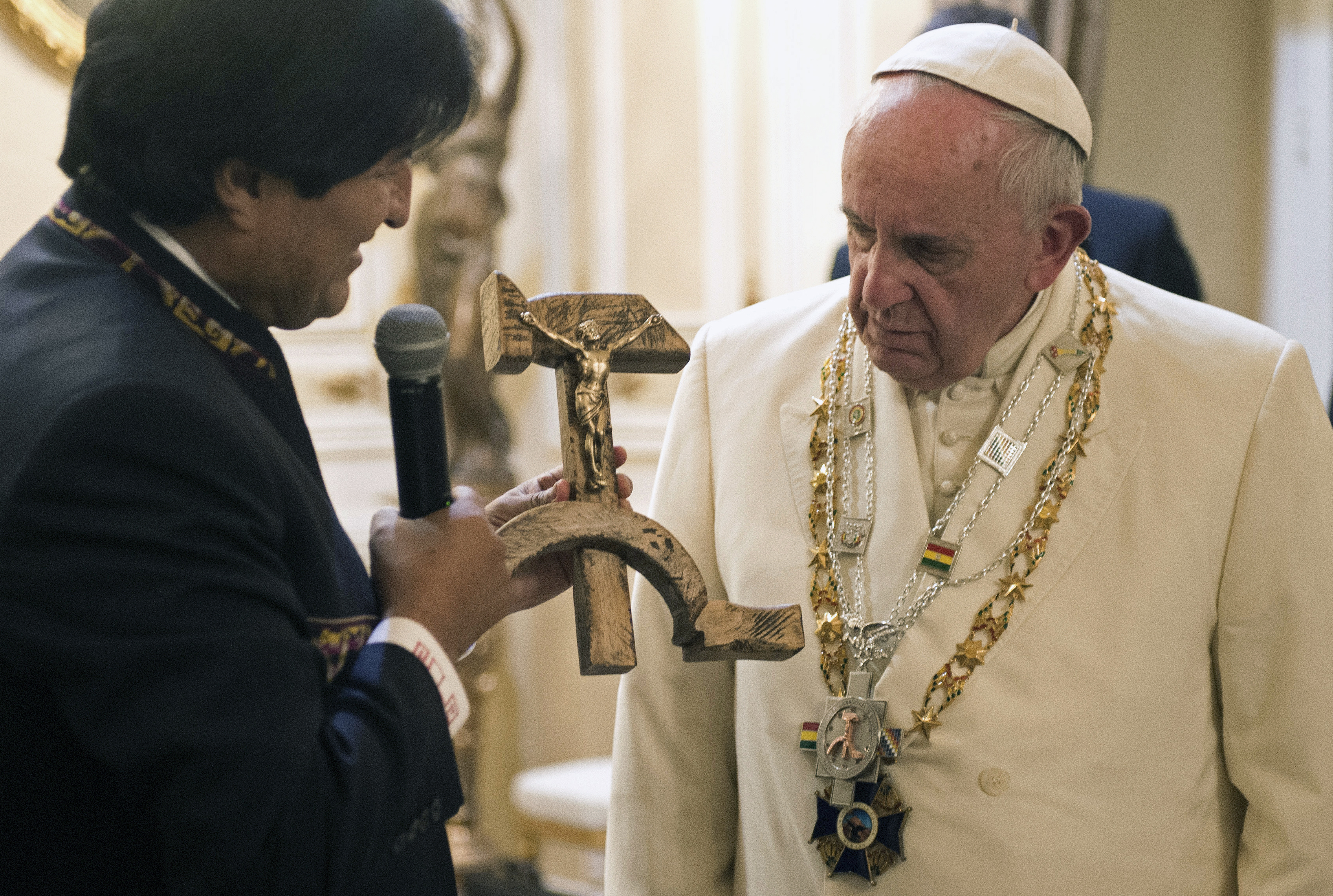 Bolivian President Evo Morales presents Pope Francis with a crucifix carved into a wooden hammer and sickle, in La Paz, Bolivia, on July 8, 2015. (L'Osservatore Romano/AP)