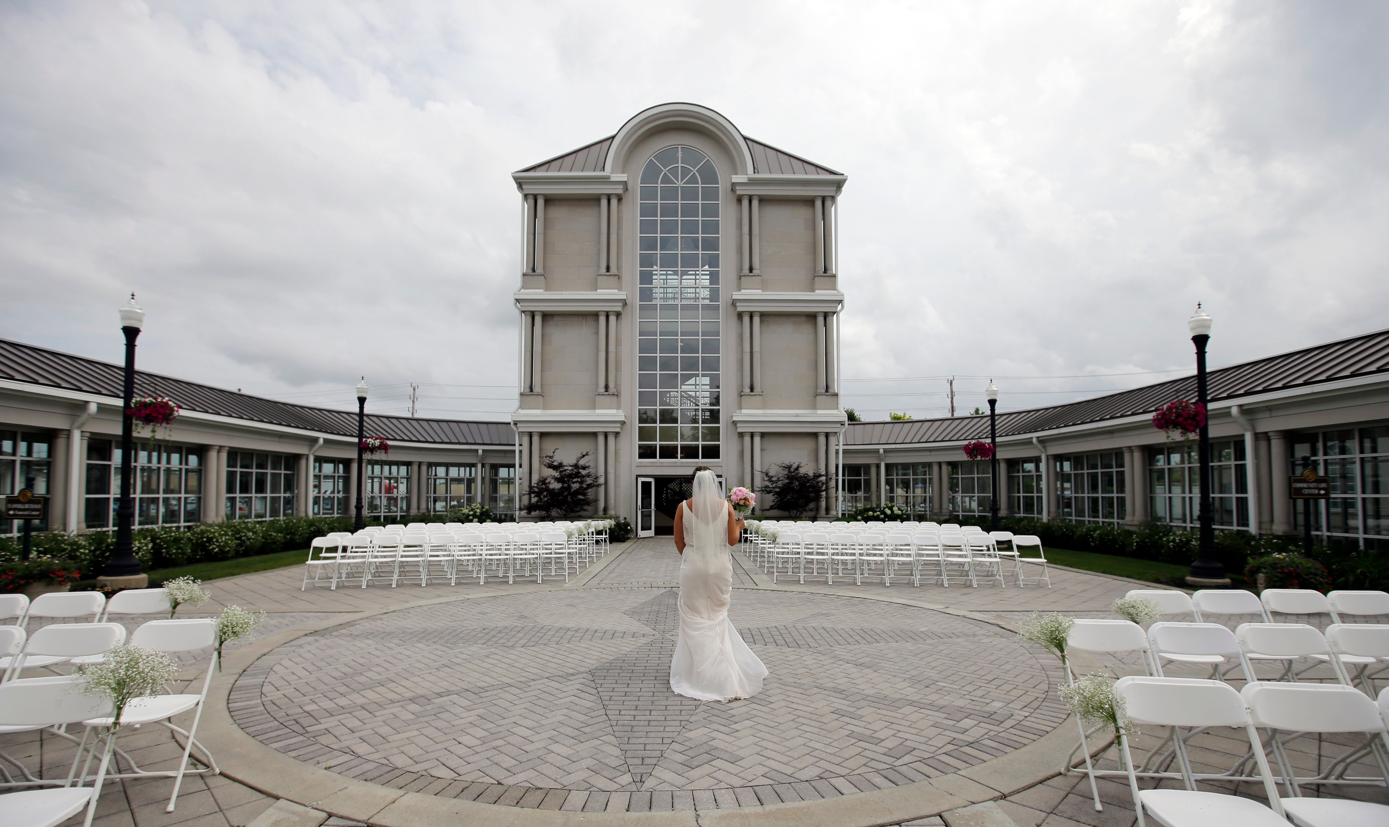 Danessa Molinder walks toward the Crystal Tower for photos before her wedding at the Community Life Center, which sits on cemetery land near a funeral home in Indianapolis. (Darron Cummings&mdash;AP)