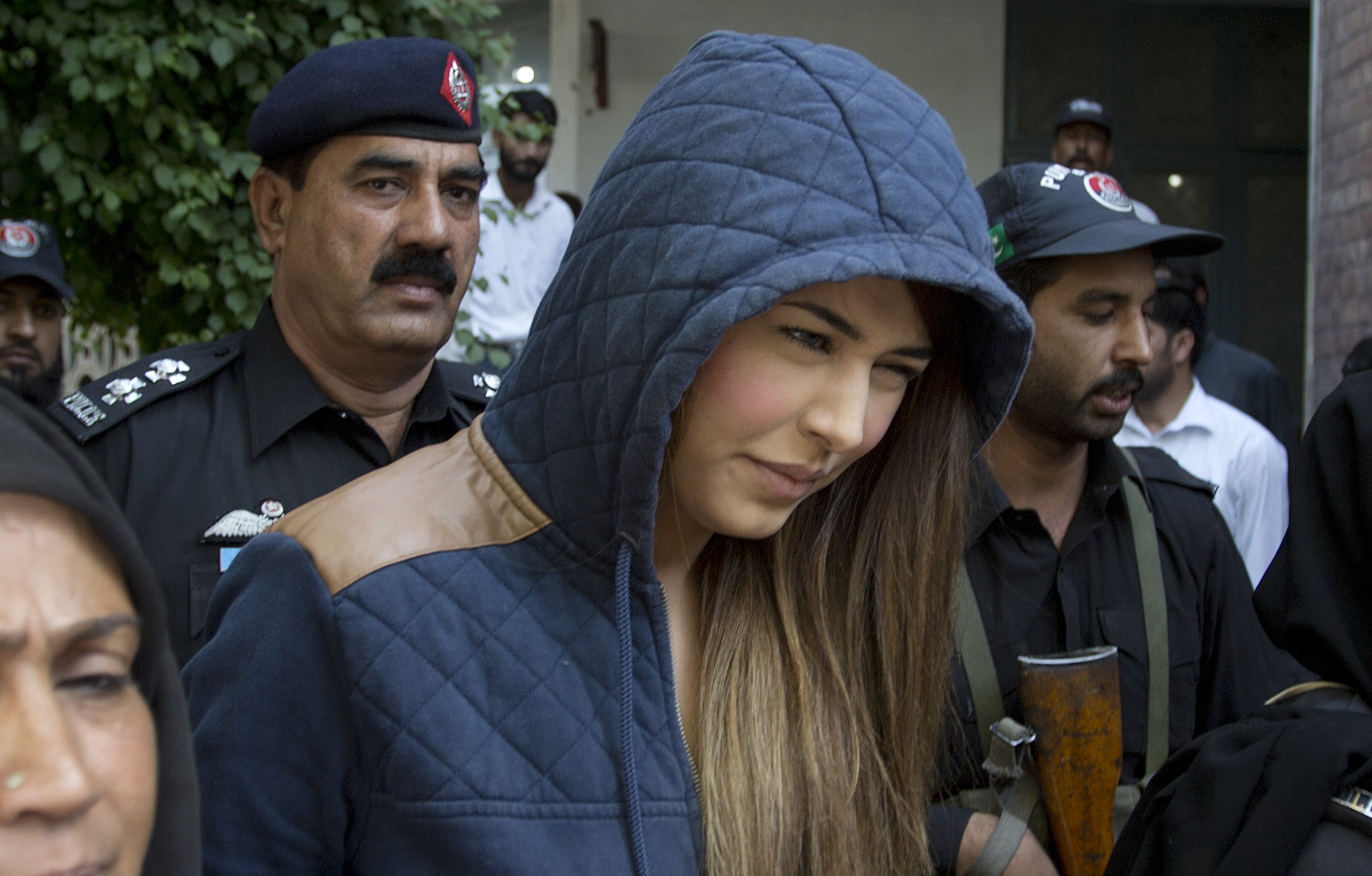 Police officers escort Pakistan's supermodel Ayaan Ali to a court under tight security in Rawalpindi, Pakistan, on June 1, 2015 (B.K. Bangash—AP)