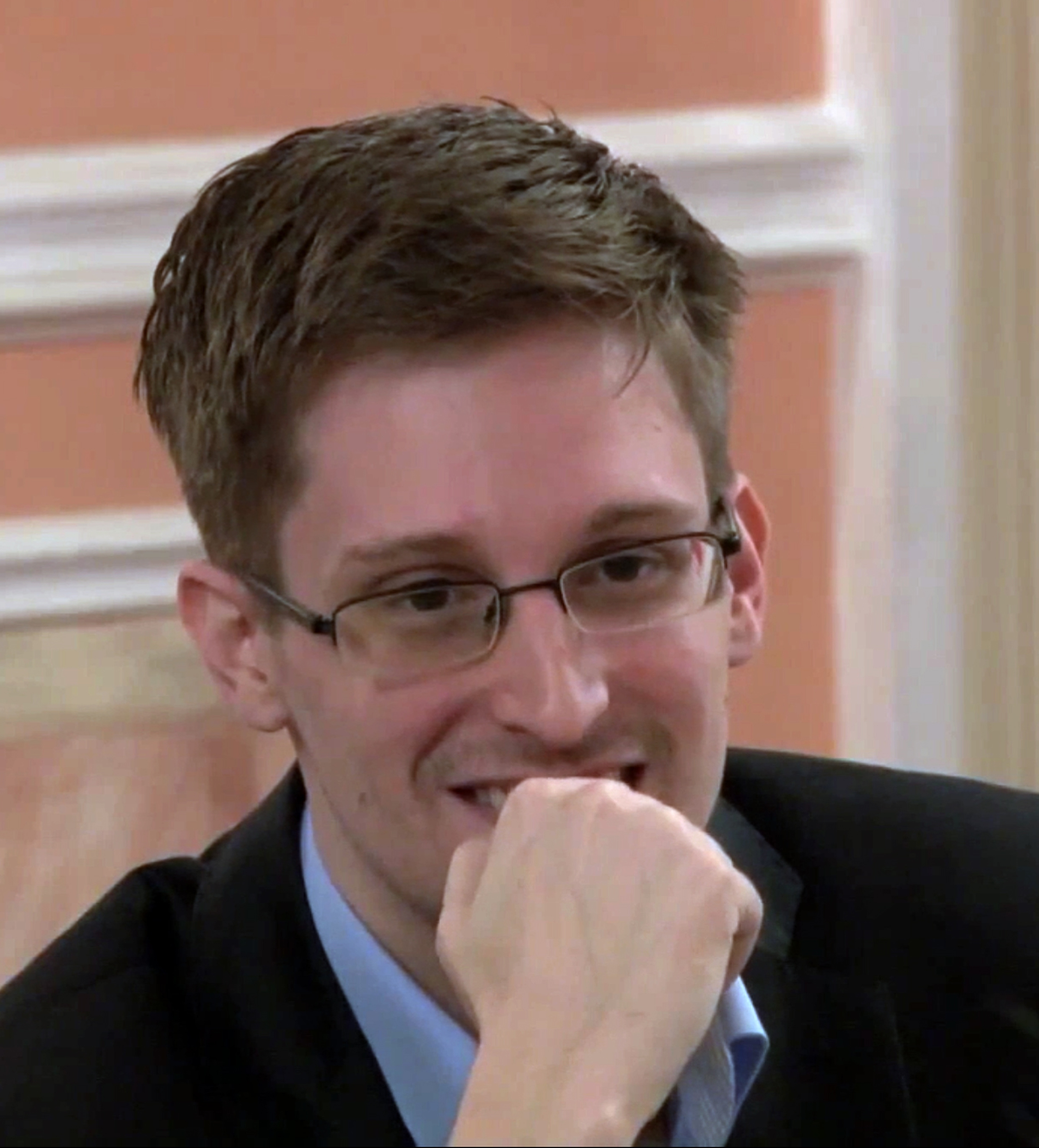 This file photo image made from video released by WikiLeaks on Friday, Oct. 11, 2013, shows former National Security Agency systems analyst Edward Snowden smiles during a presentation ceremony for the Sam Adams Award in Moscow, Russia. (Uncredited—AP)