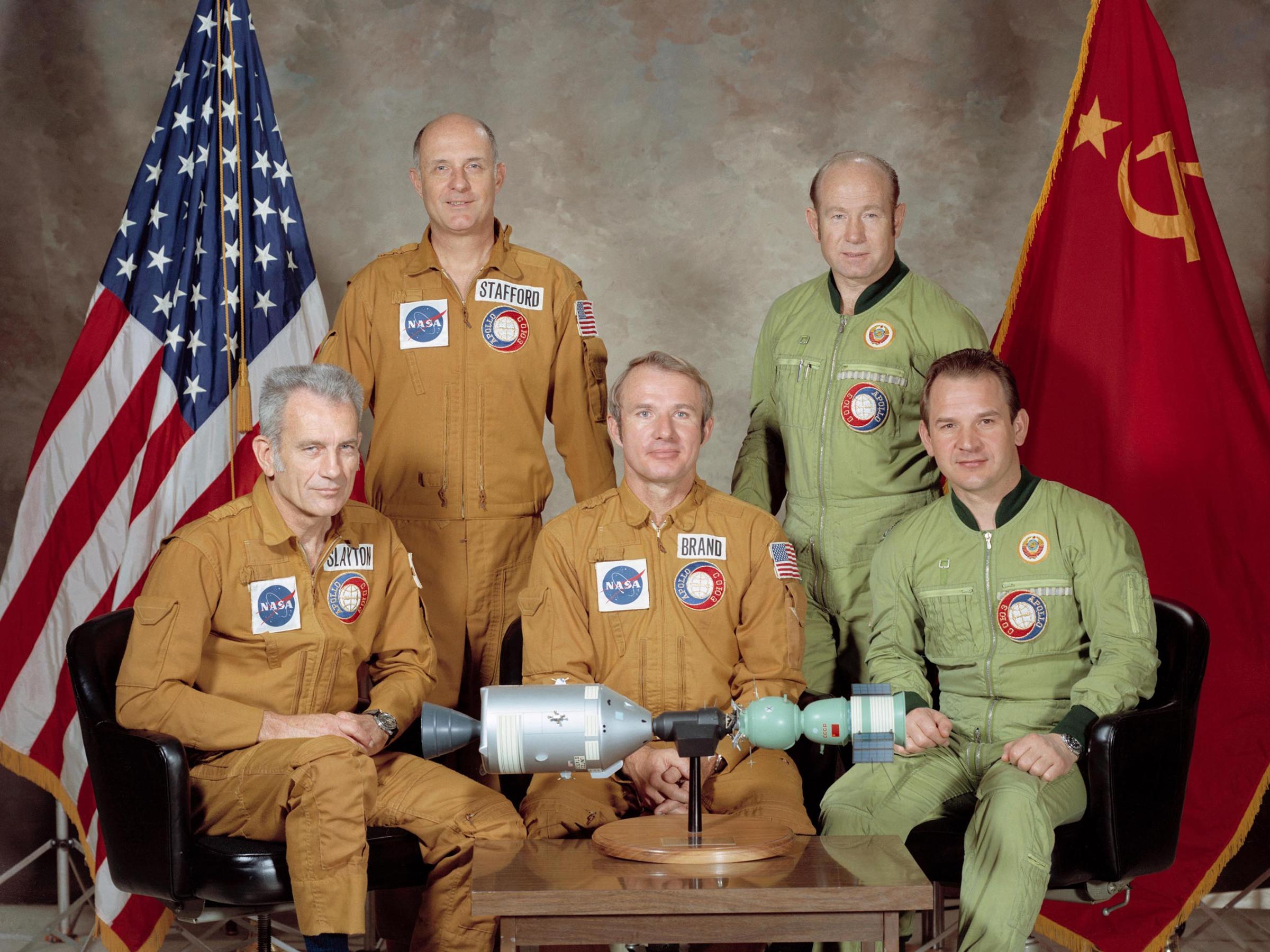 The U.S.-USSR crew for the 1975 Apollo Soyuz Test Project mission: astronaut Tom Stafford (standing on left), commander of the American crew; cosmonaut Alexei Leonov (standing on right), commander of the Soviet crew; astronaut Donald Slayton (seated on left), docking module pilot of the American crew; astronaut Vance Brand (seated in center), command module pilot of the American crew; and cosmonaut Valeriy Kubasov (seated on right), engineer on the Soviet crew.