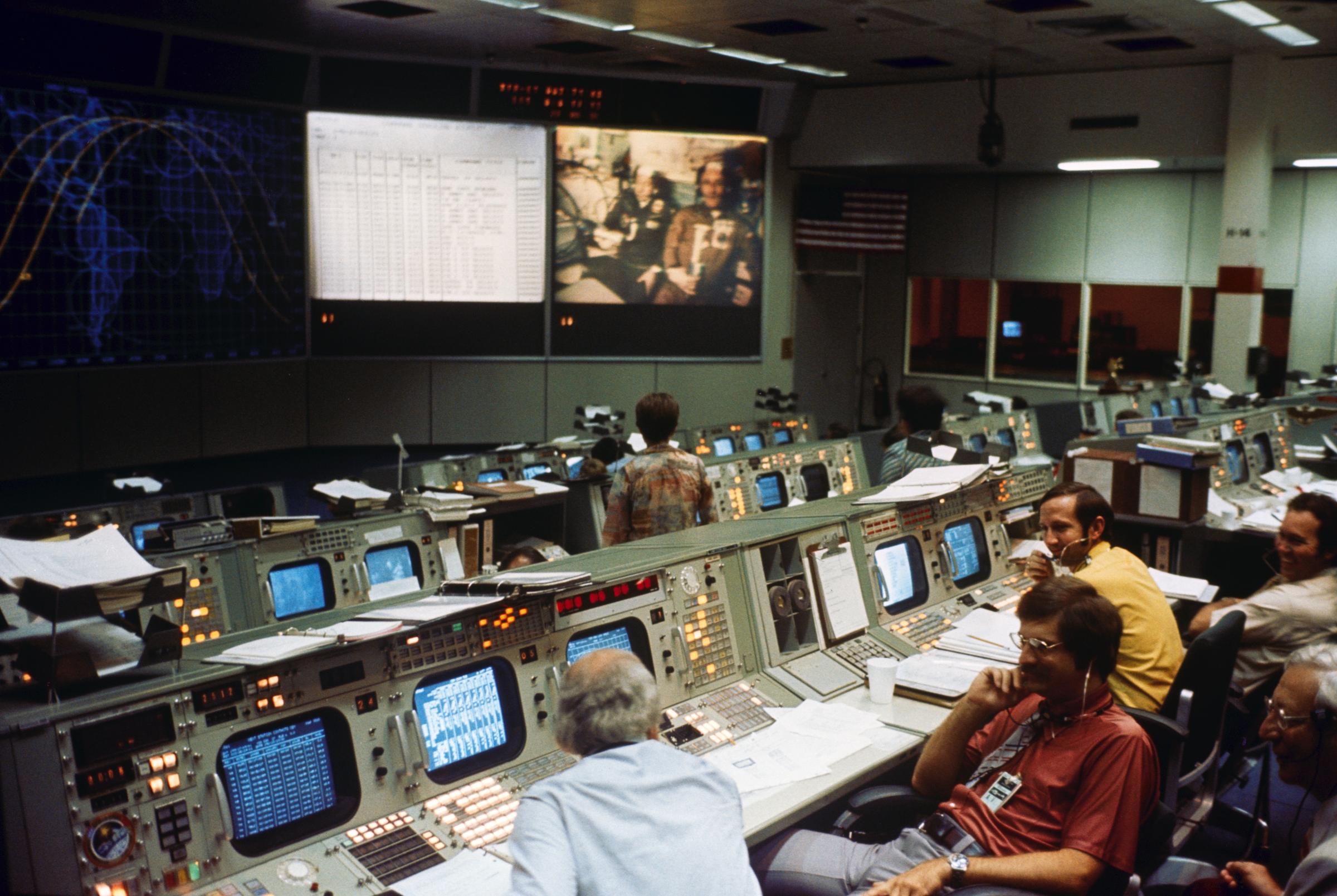 Activity inside Mission Control in Houston during the Apollo Soyuz Test Project docking mission.