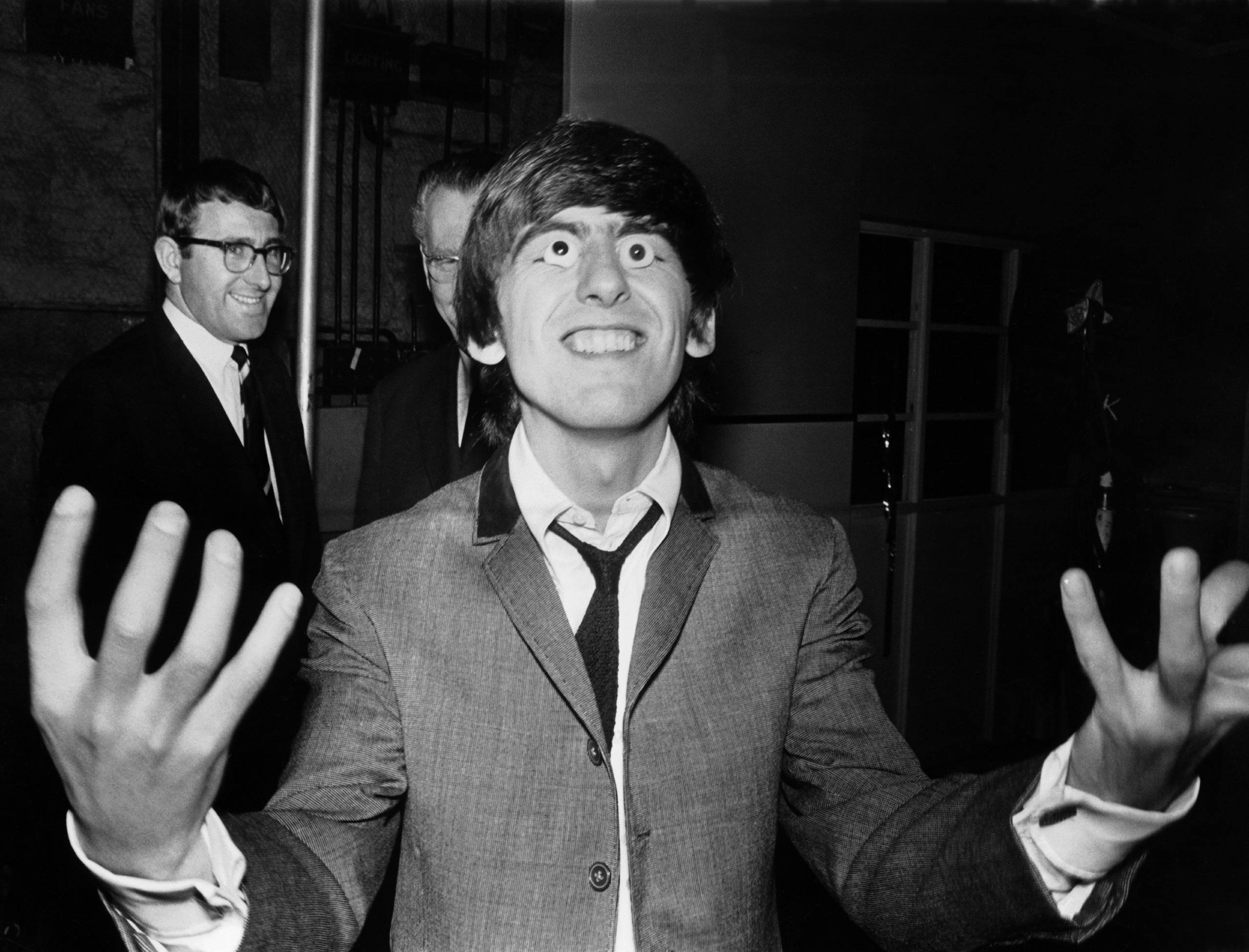 George Harrison tries out a pair of false eyes made by Madame Tussaud's waxwork museum.
