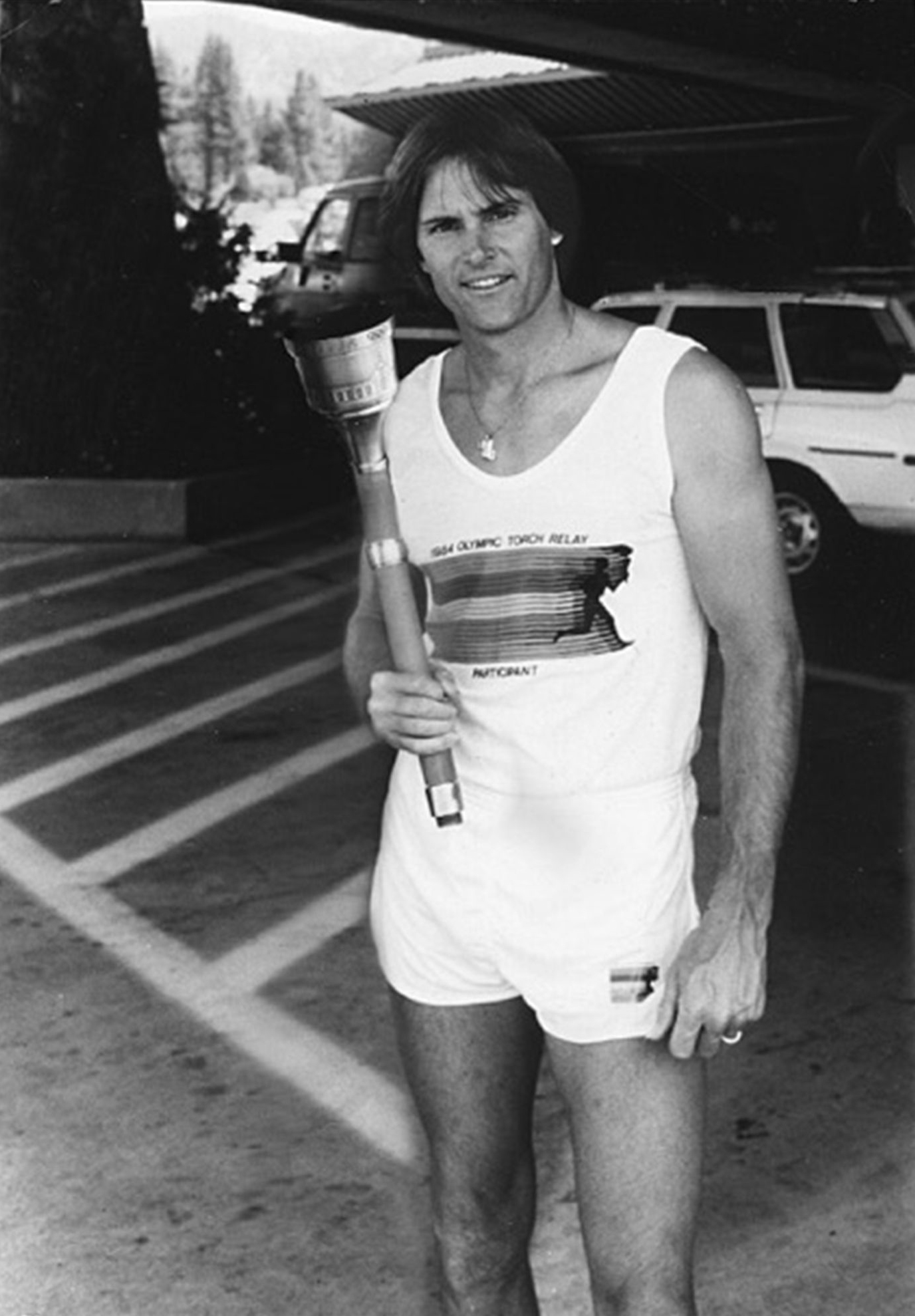 American Decathlete, Bruce Jenner poses with the 1984 Olympic Torch he carried through Lake Tahoe, Nevada.
