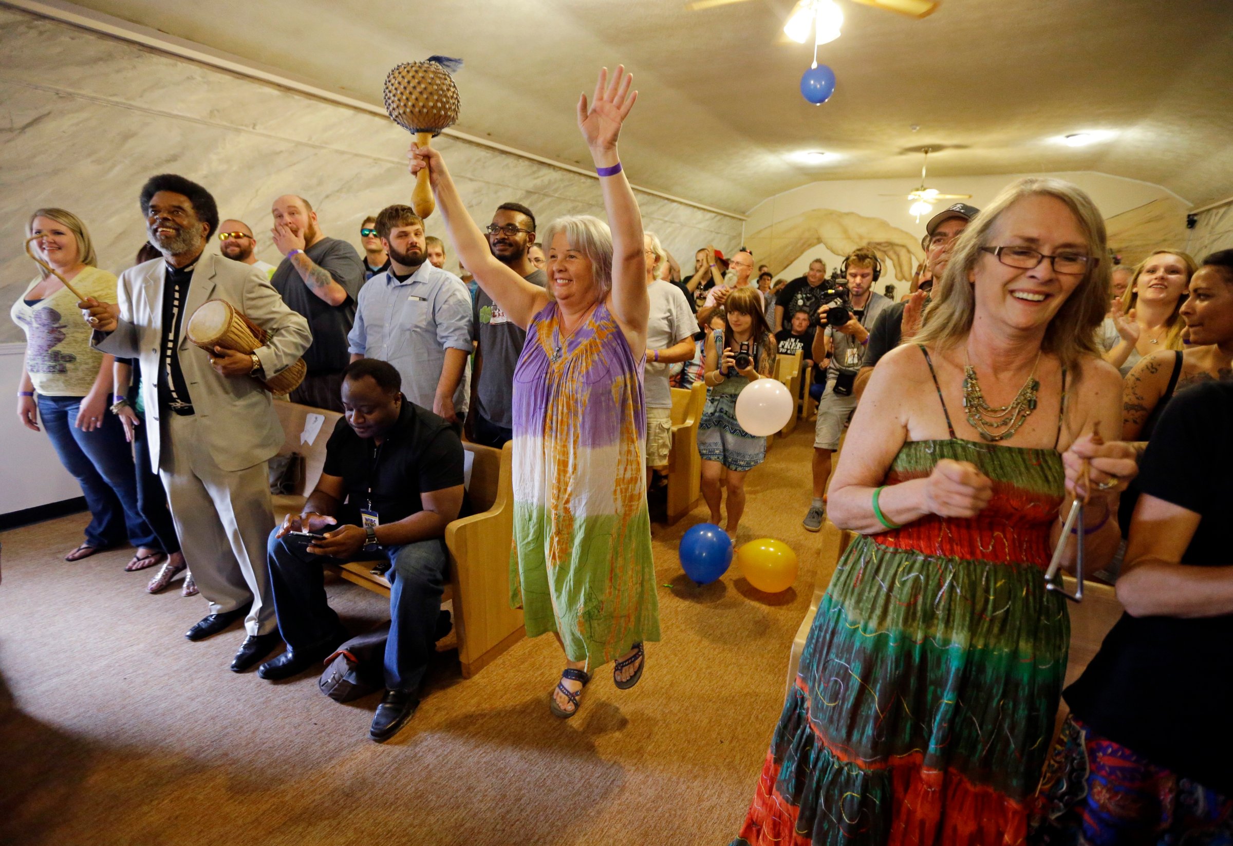Members of the congregation at the First Church of Cannabis sing and dance during the church's first service on July 1, 2015, in Indianapolis.