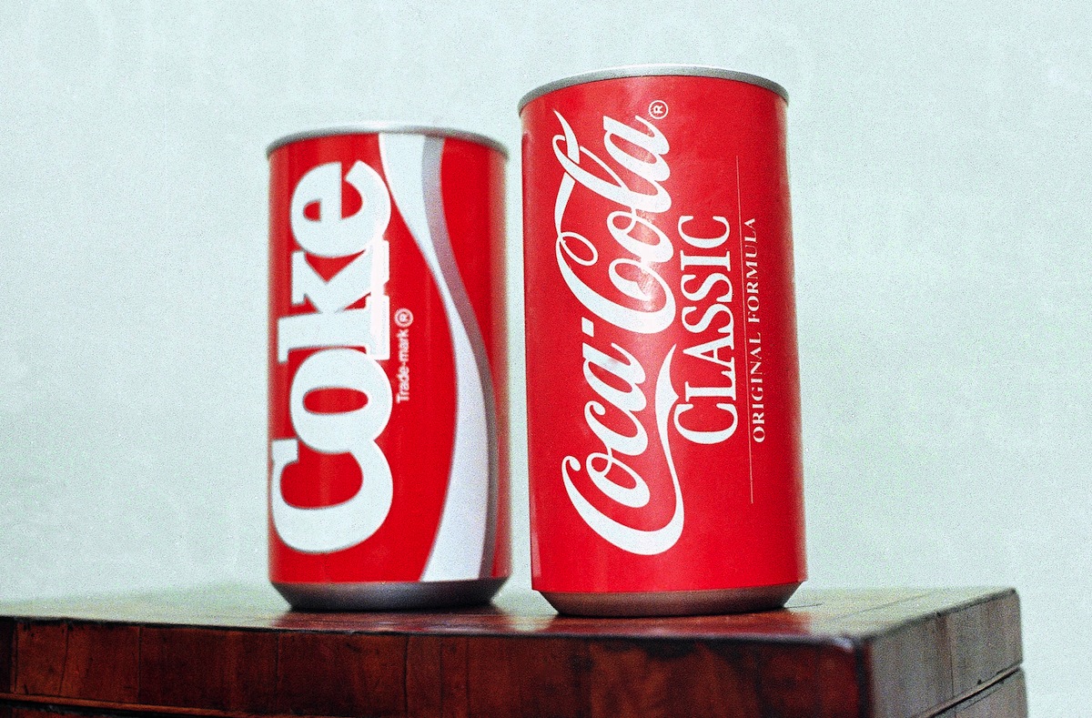 A July 11, 1985, file photo of cans of New Coke and Coca-Cola Classic  on display during a news conference in Atlanta. (Charles Kelly—AP Images)