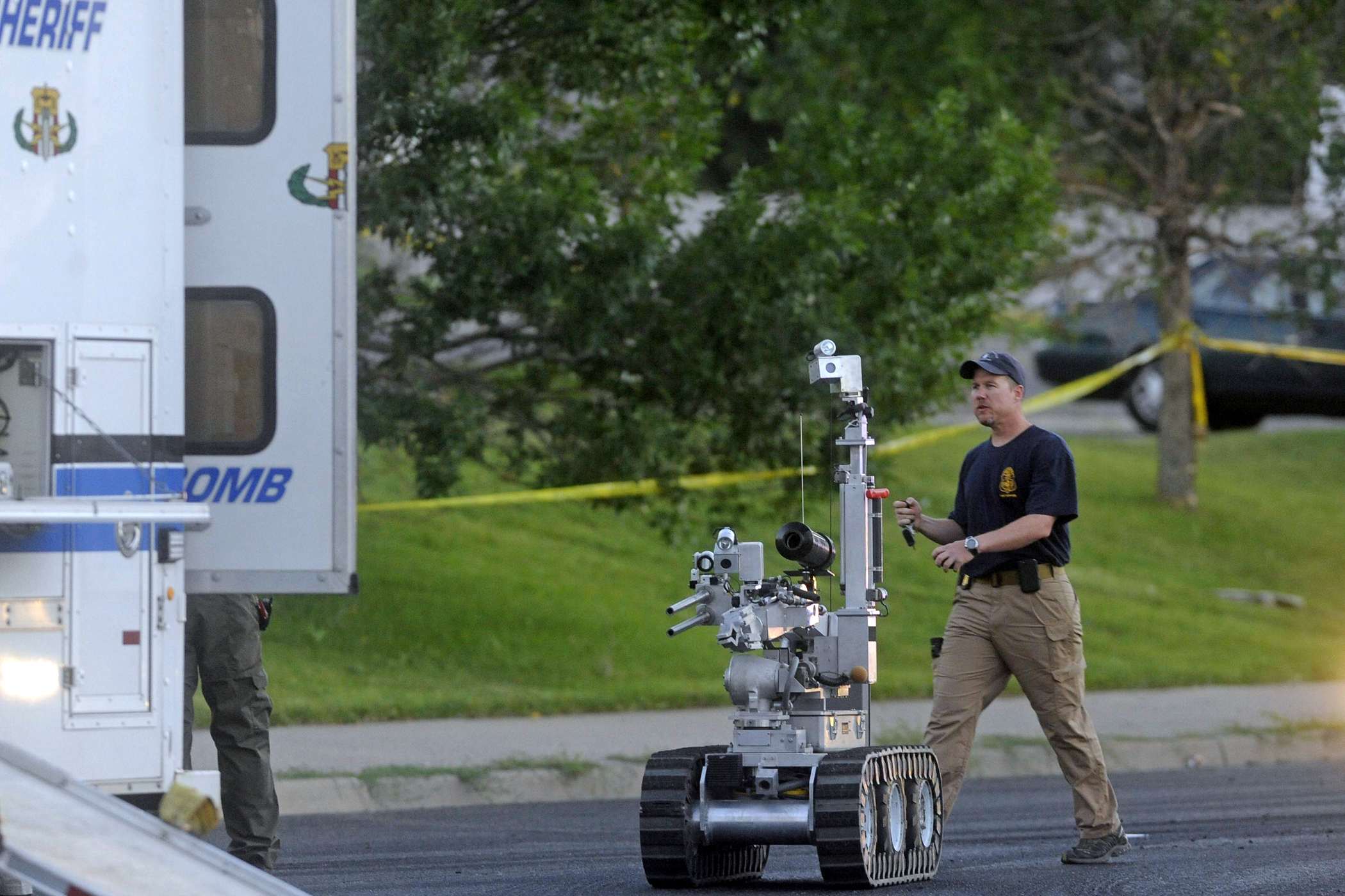 The Aurora bomb squad robot is deployed to search a suspect's car after shooting in Aurora, Colorado