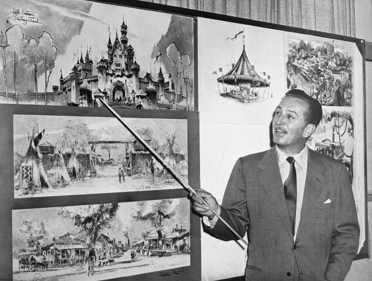 Walt Disney uses a baton to point to sketches of Disneyland, 1955. (Hulton Archive / Getty Images)