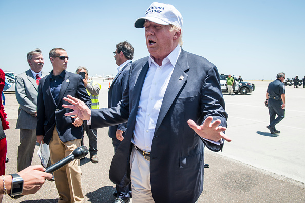 Republican Presidential candidate and business mogul Donald Trump talks to the media after exiting his plane during his trip to the border on July 23, 2015 in Laredo, Texas.