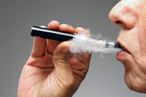 A person smokes an e-cigarette. (Victor de Schwanber—Getty Images)