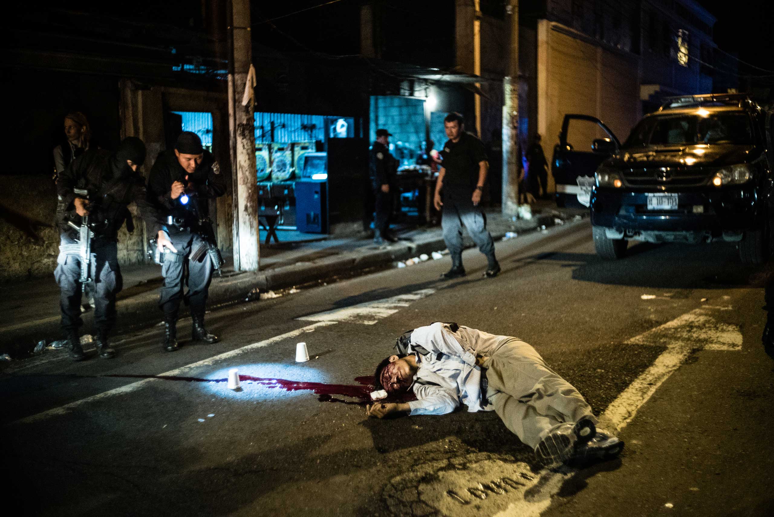 Police investigate 
                              a murder in 
                              the capital, on May 21, 2015.