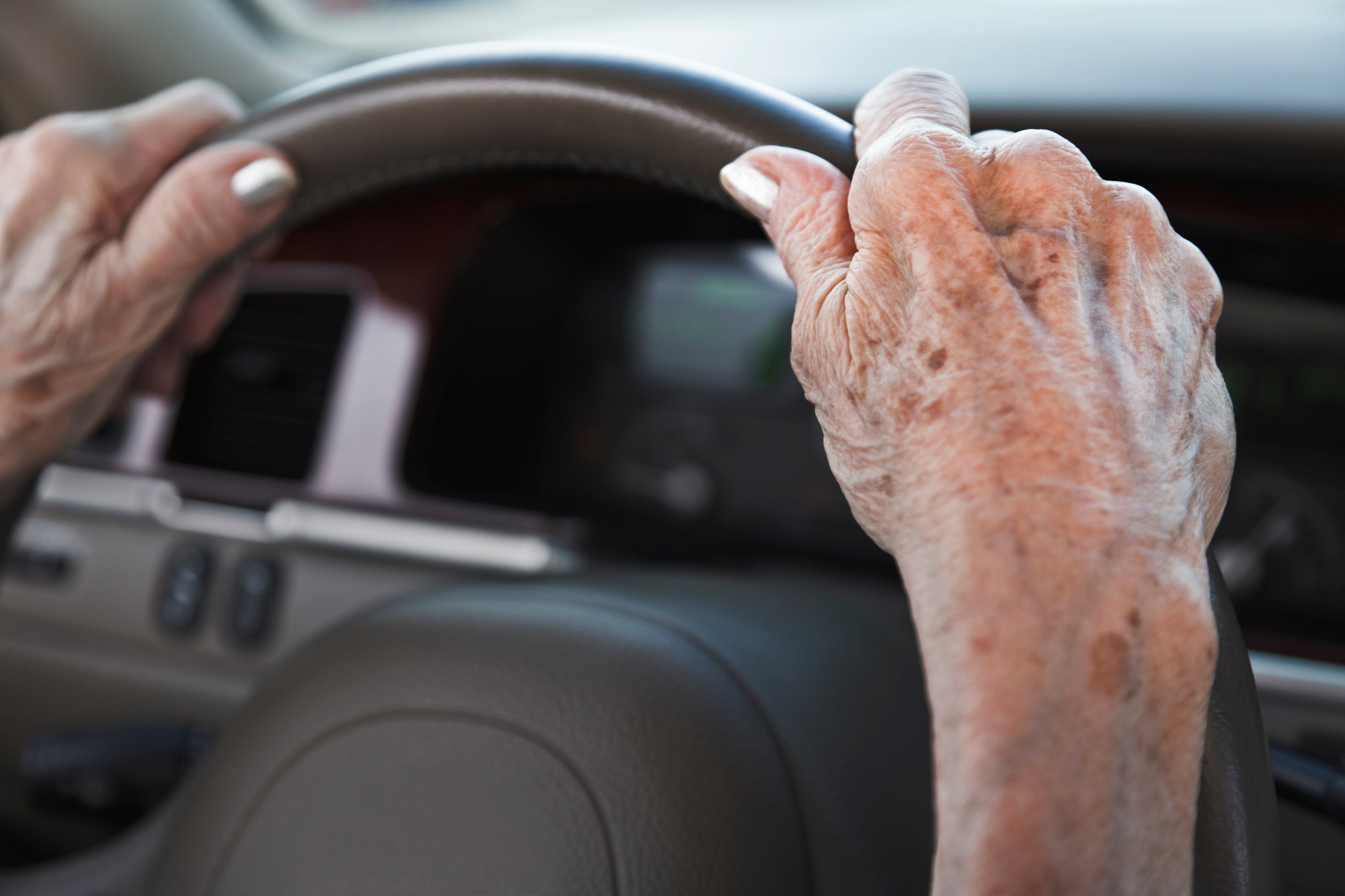 senior woman hands on steering wheel