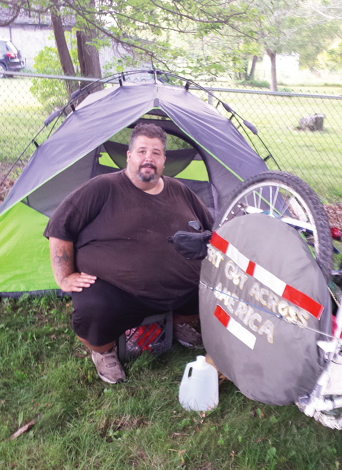 Eric Hites, rests at the Bliss Congregational Church in Tiverton, R.I on July 21, 2015, while he waits for a new bicycle so he can continue his cross-country ride. The about 560-pound man is biking across the United States to lose weight.