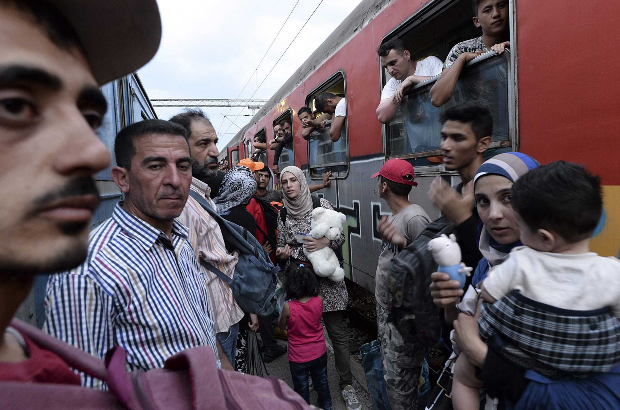 Migrants react after they couldn't find a seat on the train heading to the Serbian border, where they will migrate towards Western European nations, at the train station in Gevgelija, Macedonia, July 26, 2015. (Georgi Licovski—EPA)