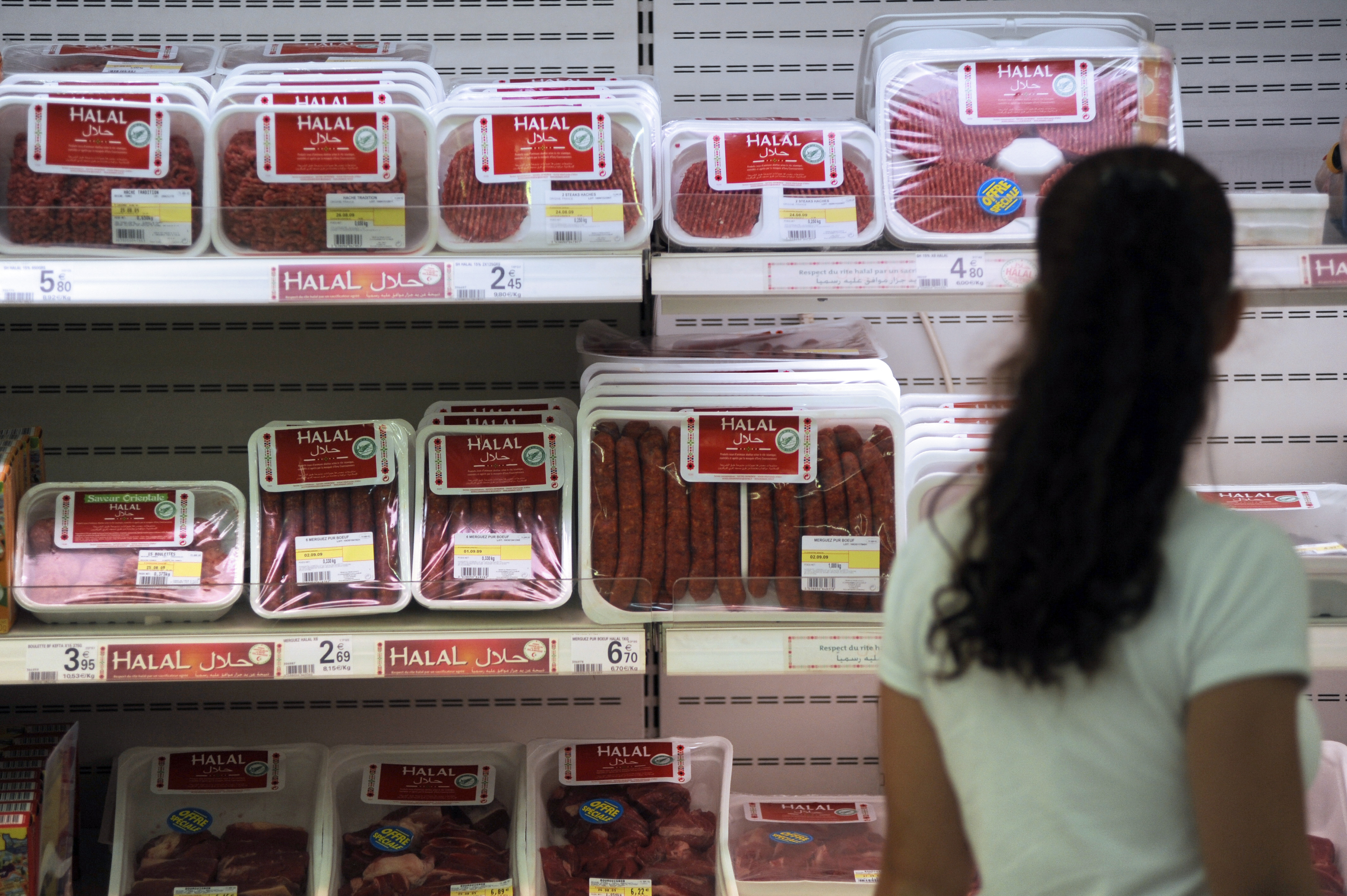 A customer passes by Halal butchery shelves in a supermarket in Illzach, eastern France, on Aug. 21, 2009.
