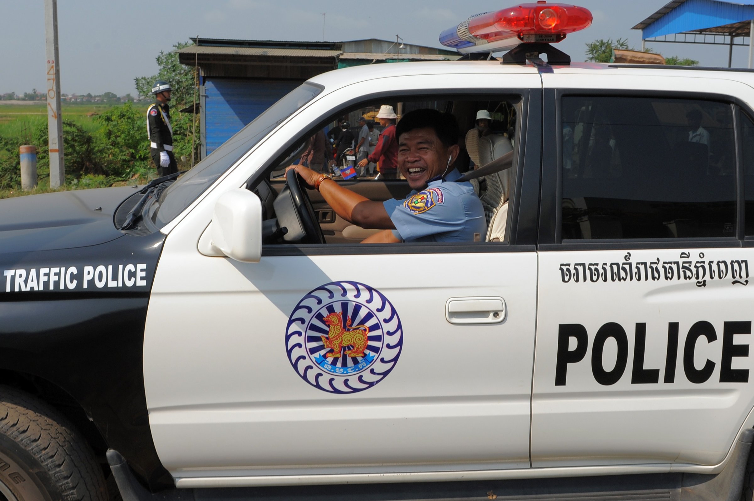 A Cambodian traffic police drives a car