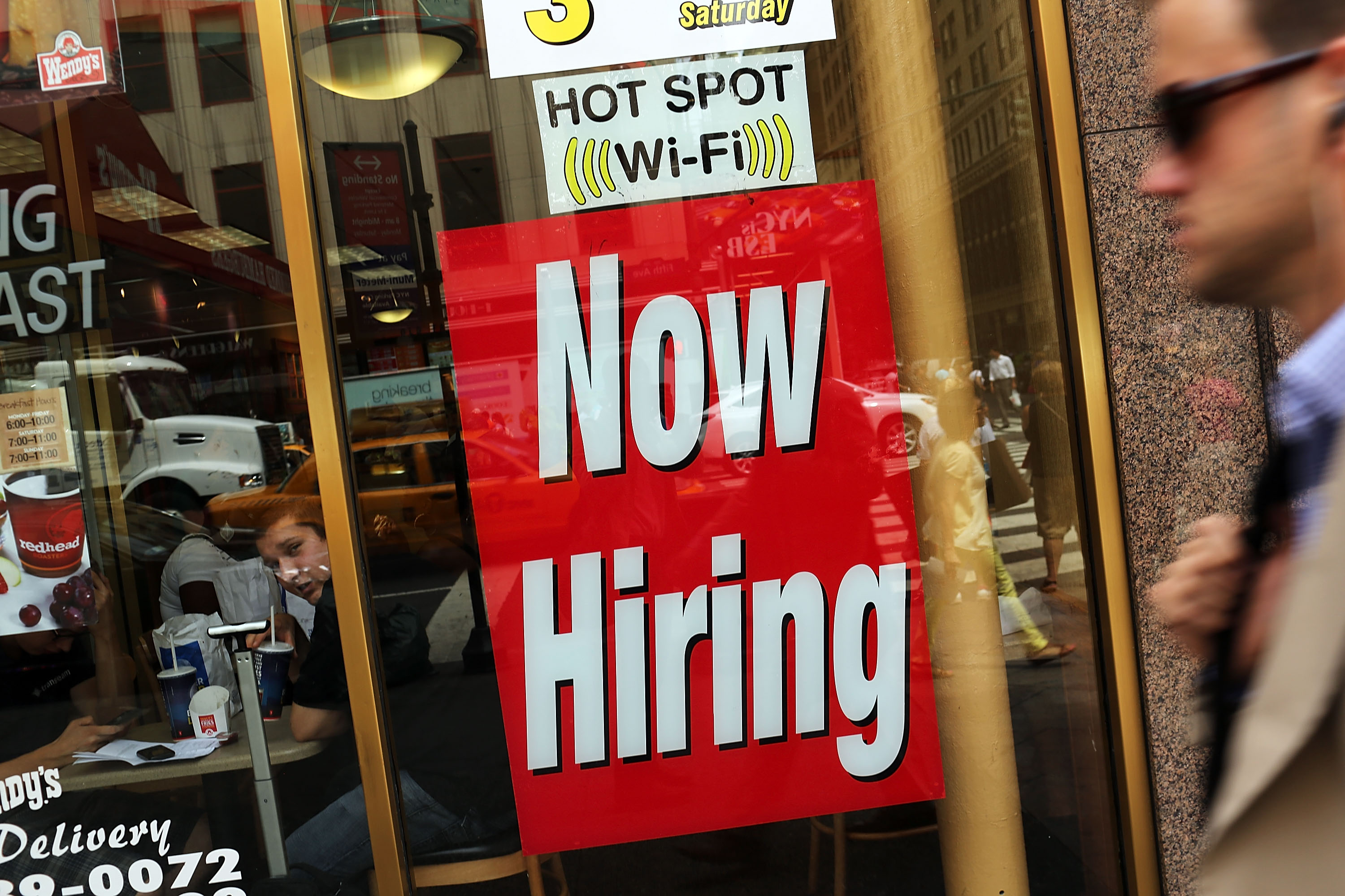 A "now hiring" sign is viewed in the window of a fast food restaurant on August 7, 2012 in New York City. (Spencer Platt&mdash;Getty Images)