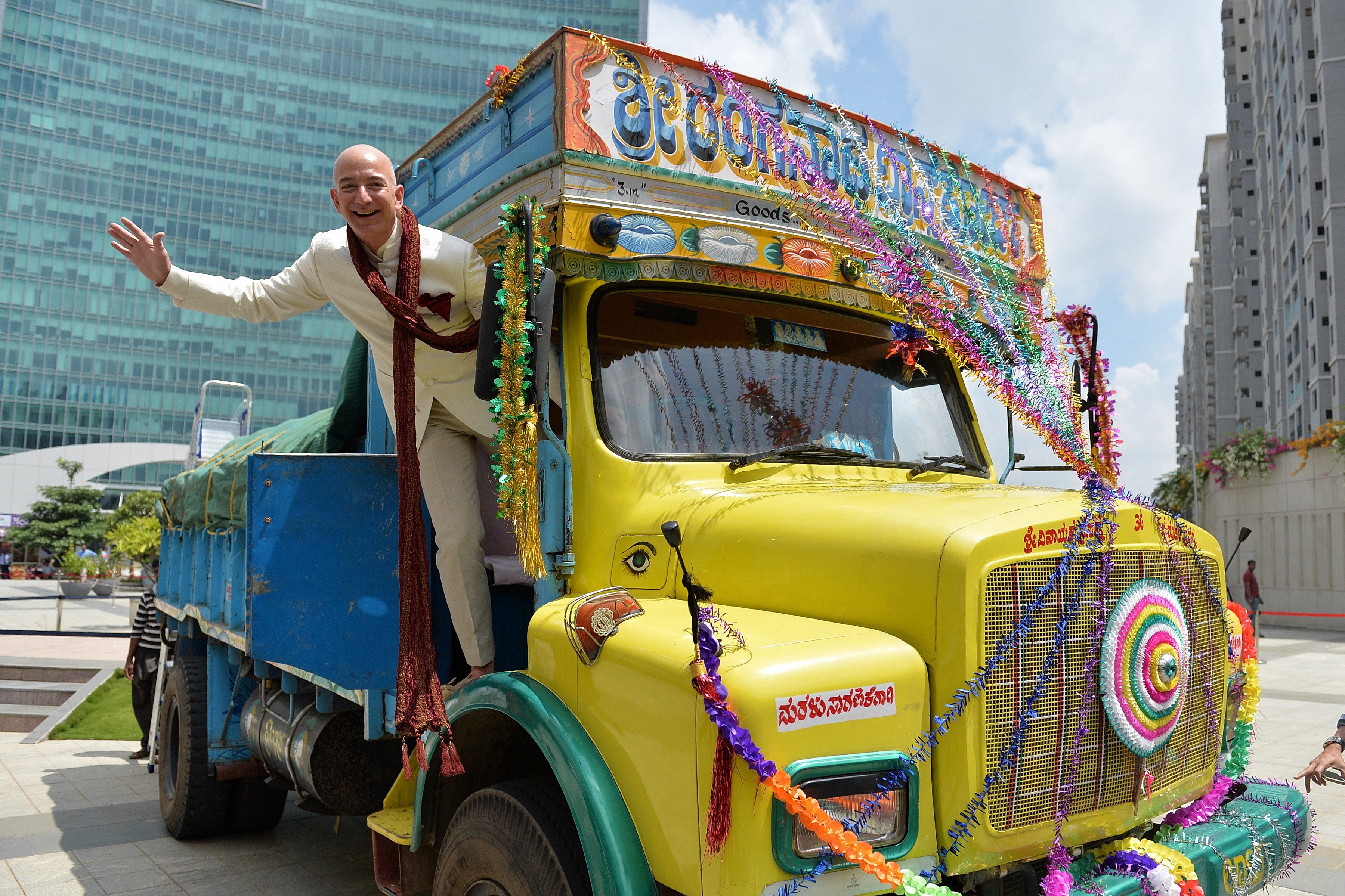 CEO of Amazon.com Jeff Bezos poses on a lorry in Bangalore on Sept. 28, 2014 (Manjunath Kiran—AFP/Getty Images)