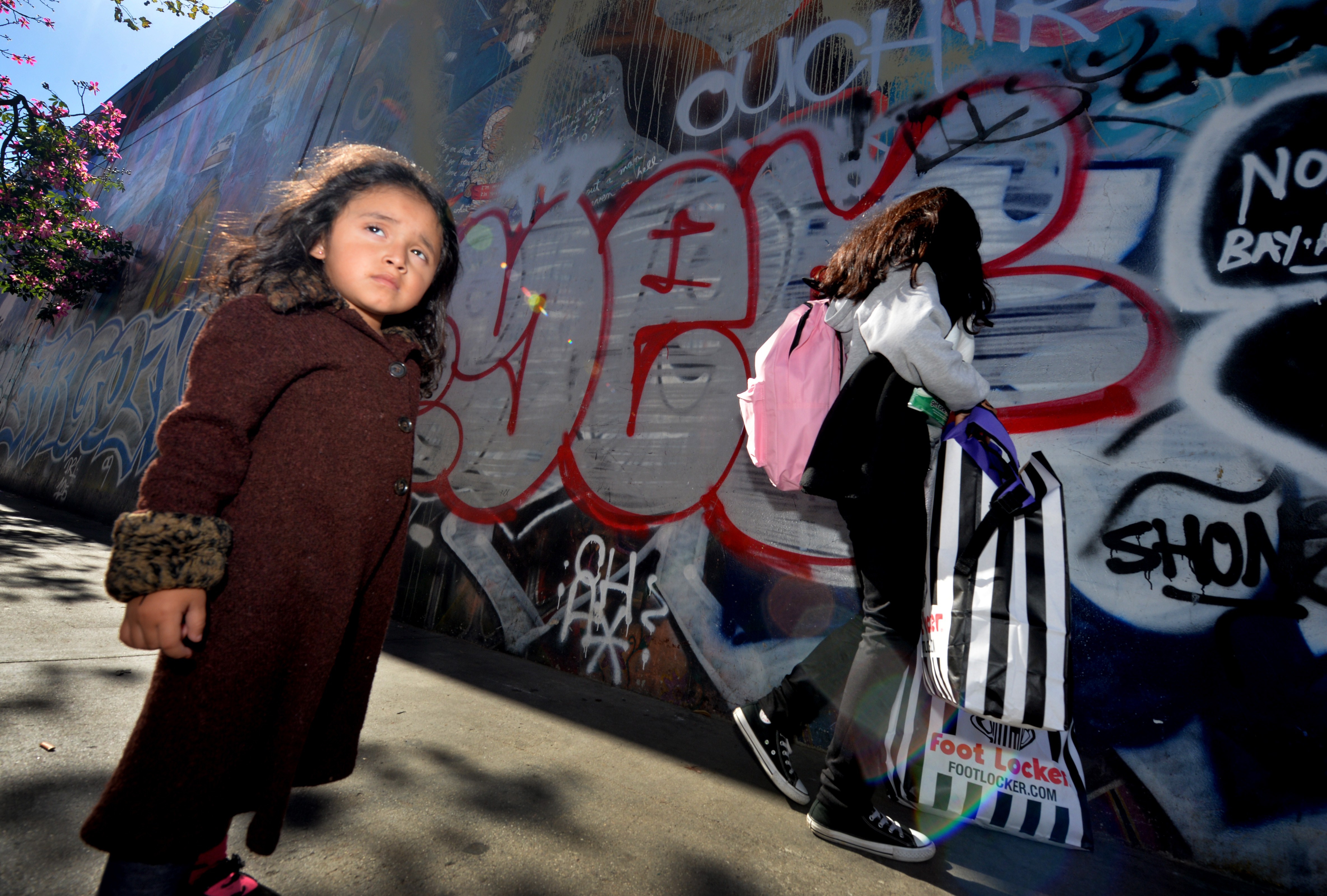 Three year old Saria Amaya (L) waits with her mother after receiving shoes and school supplies during a charity event to help more than 4,000 underprivileged children at the Fred Jordan Mission in the Skid Row area of Los Angeles on October 2, 2014. (MARK RALSTON--AFP/Getty Images)
