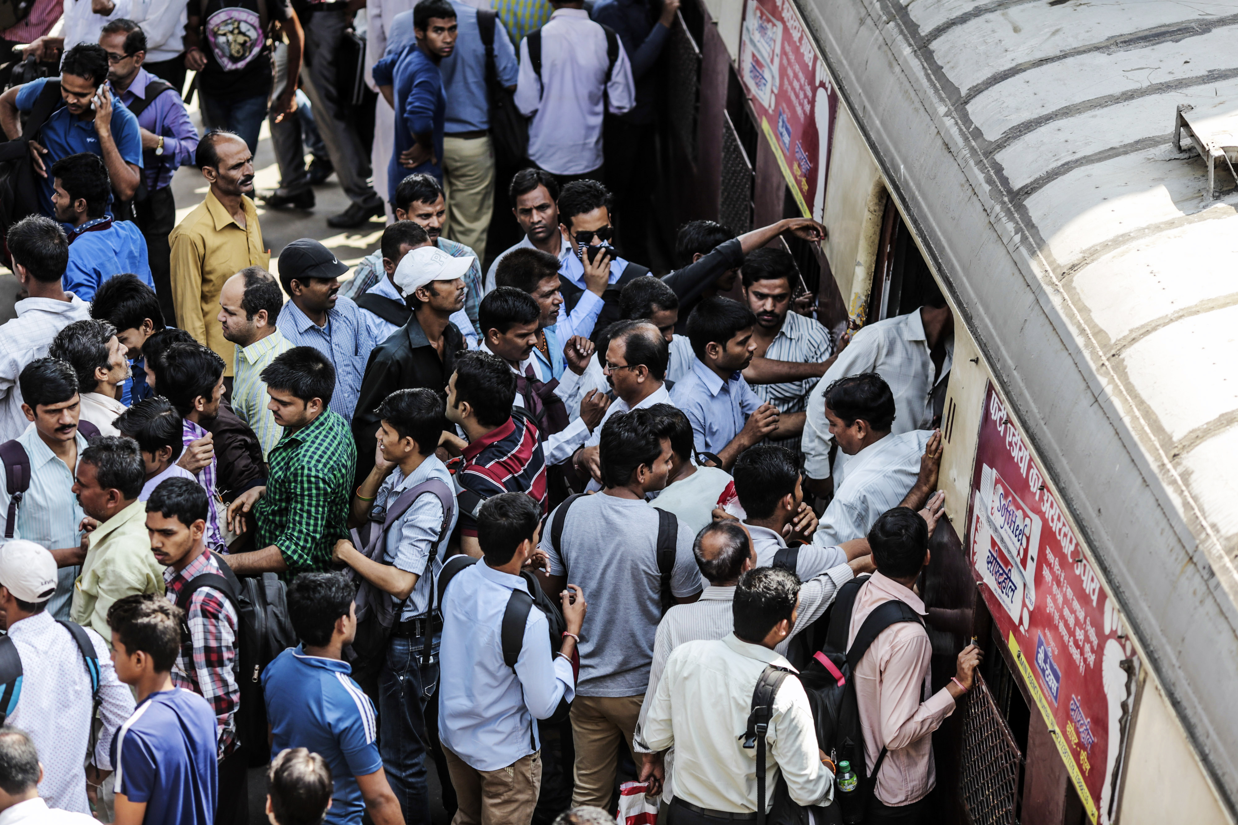Passengers disembark as commuters wait to board a train during the morning rush hour at Kurla railway station in Mumbai, India, on Wednesday, April 15, 2015. (Dhiraj Singh—Bloomberg/Getty Images)