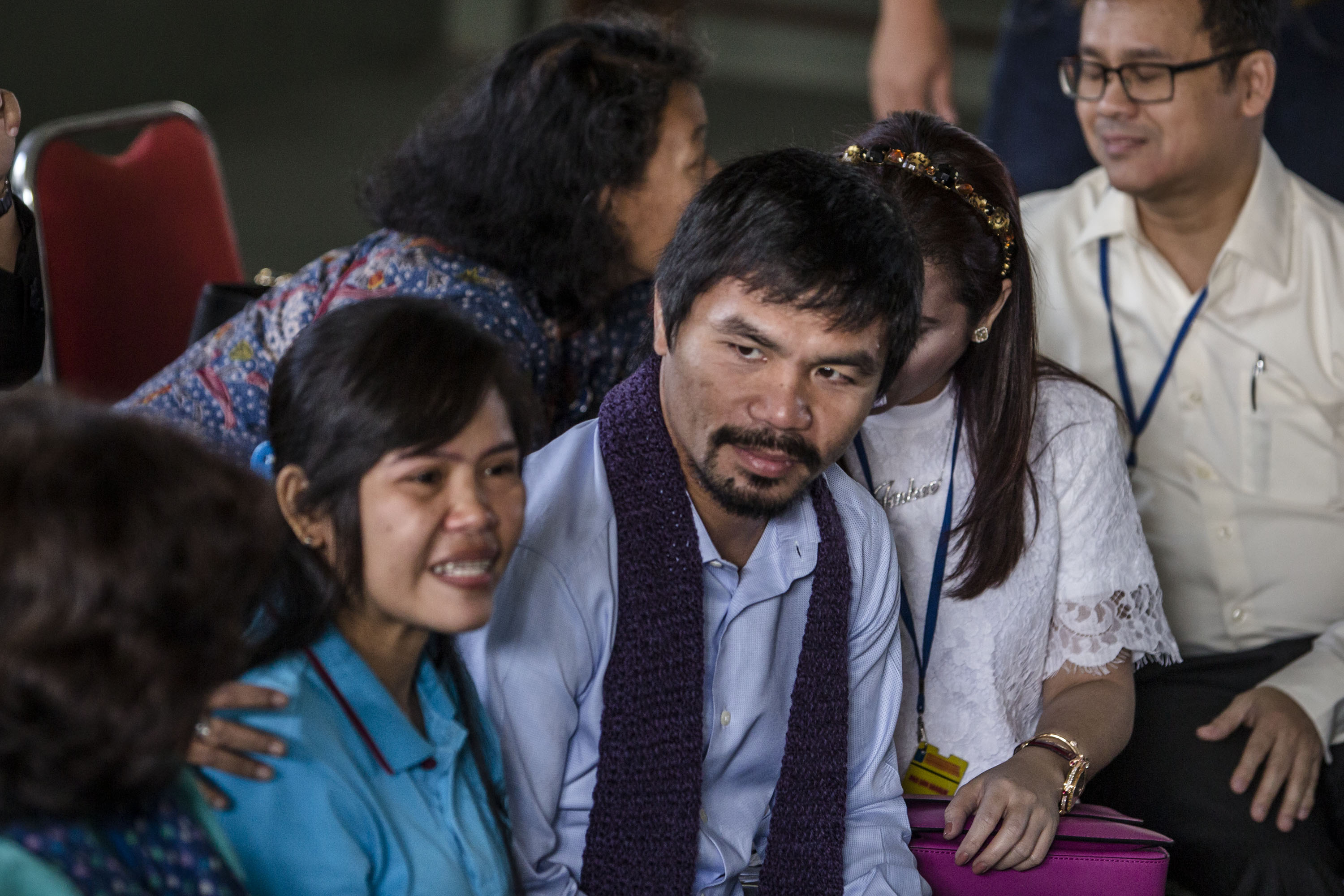 Filipino boxing icon Manny Pacquiao, center, and his wife Jinkee meet convicted drug trafficker Mary Jane Veloso of the Philippines during a visit at Wirogunan prison on July 10, 2015, in Yogyakarta, Indonesia (Ulet Ifansasti—Getty Images)