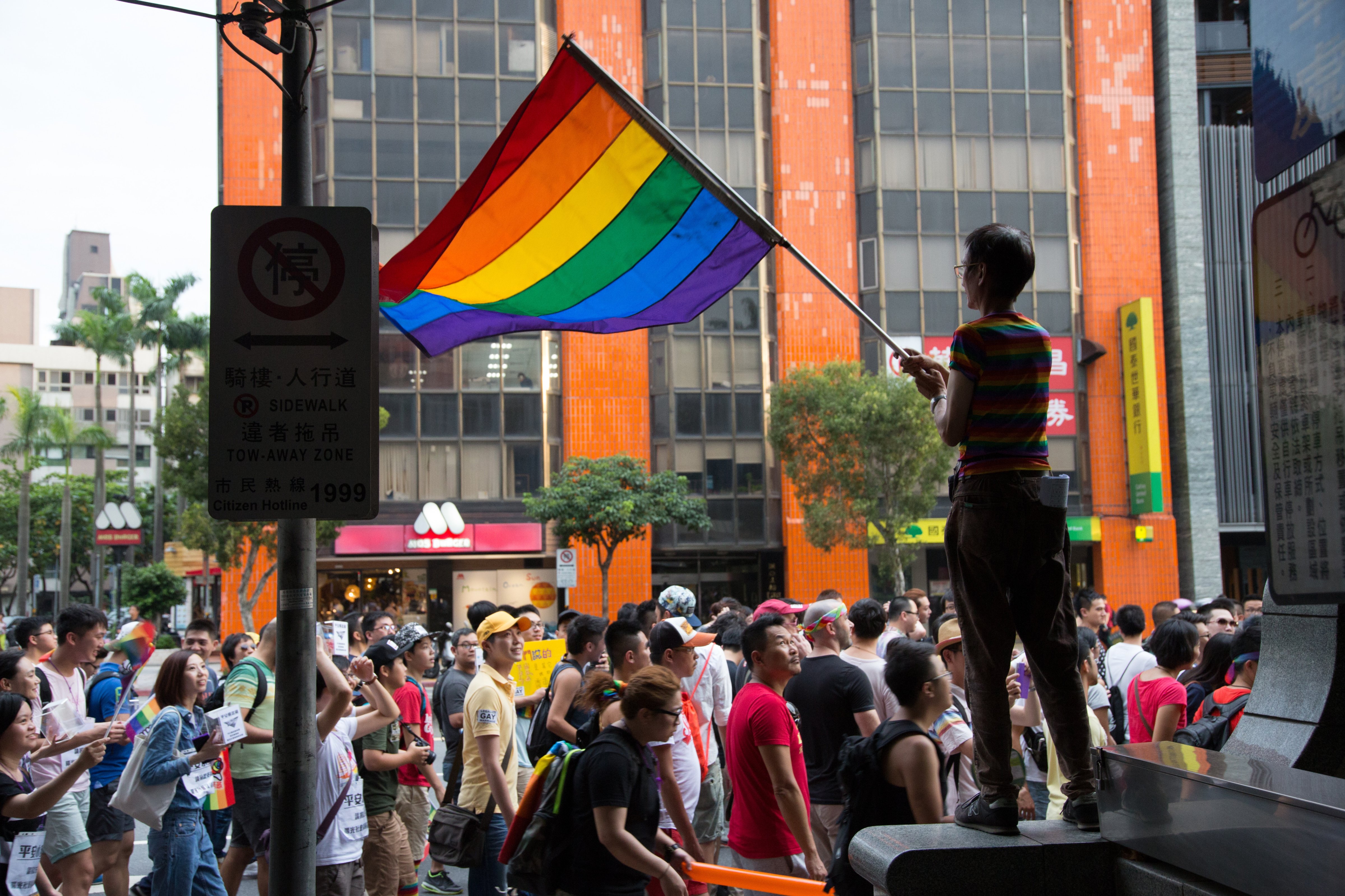 A man waves the LGBT rainbow flag in support of gay marriage as a campaign march calling for the legalization of gay marriage passes by.  (Craig Ferguson/LightRocket-- Getty Images) (Craig Ferguson&mdash;LightRocket via Getty Images)