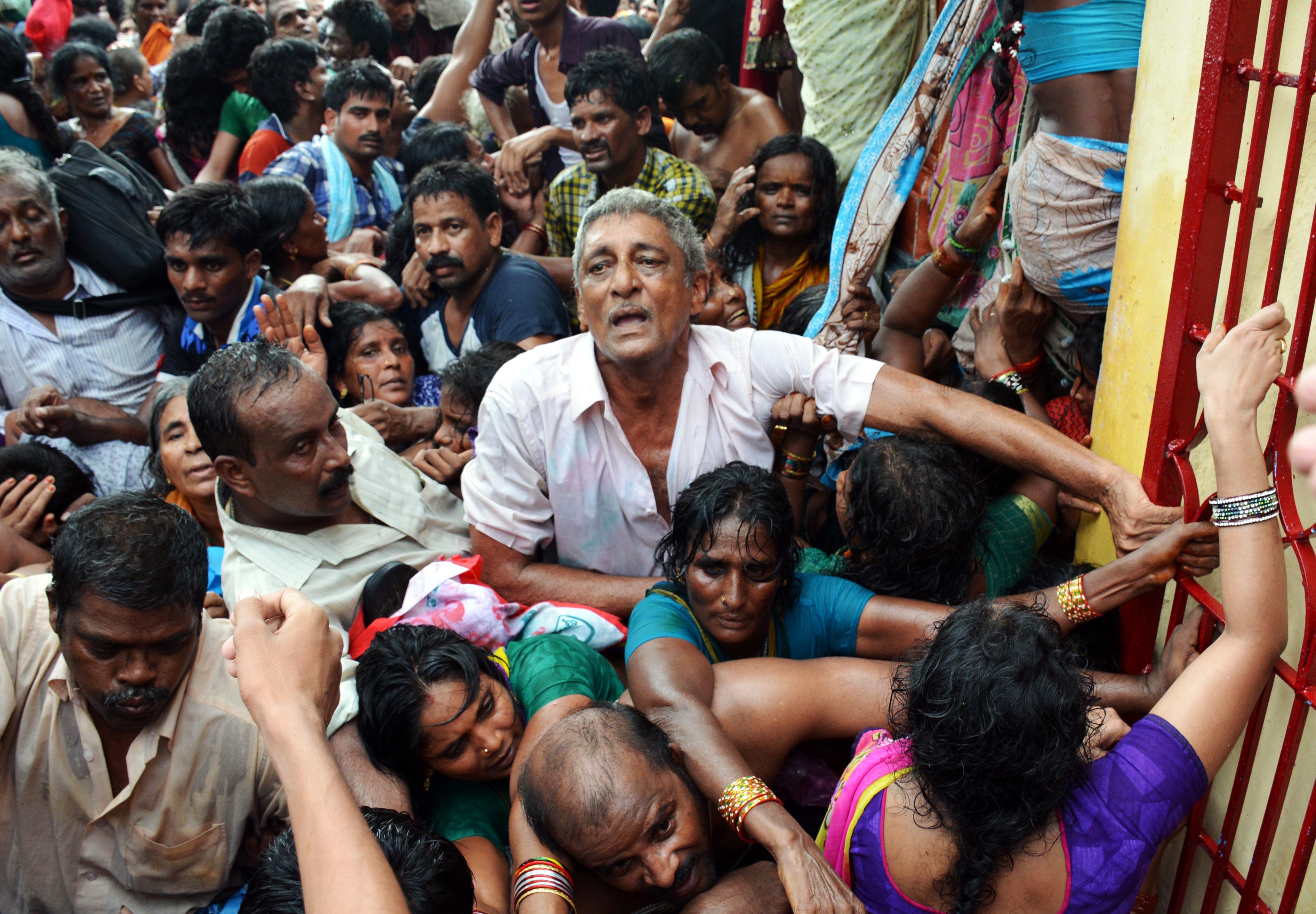 Indian devotees gather after a stampede at a religious festival in Godavari in the Rajahmundry district some 200 kms north-east of Hyderabad on July 14, 2015. (STRDEL—AFP/Getty Images)