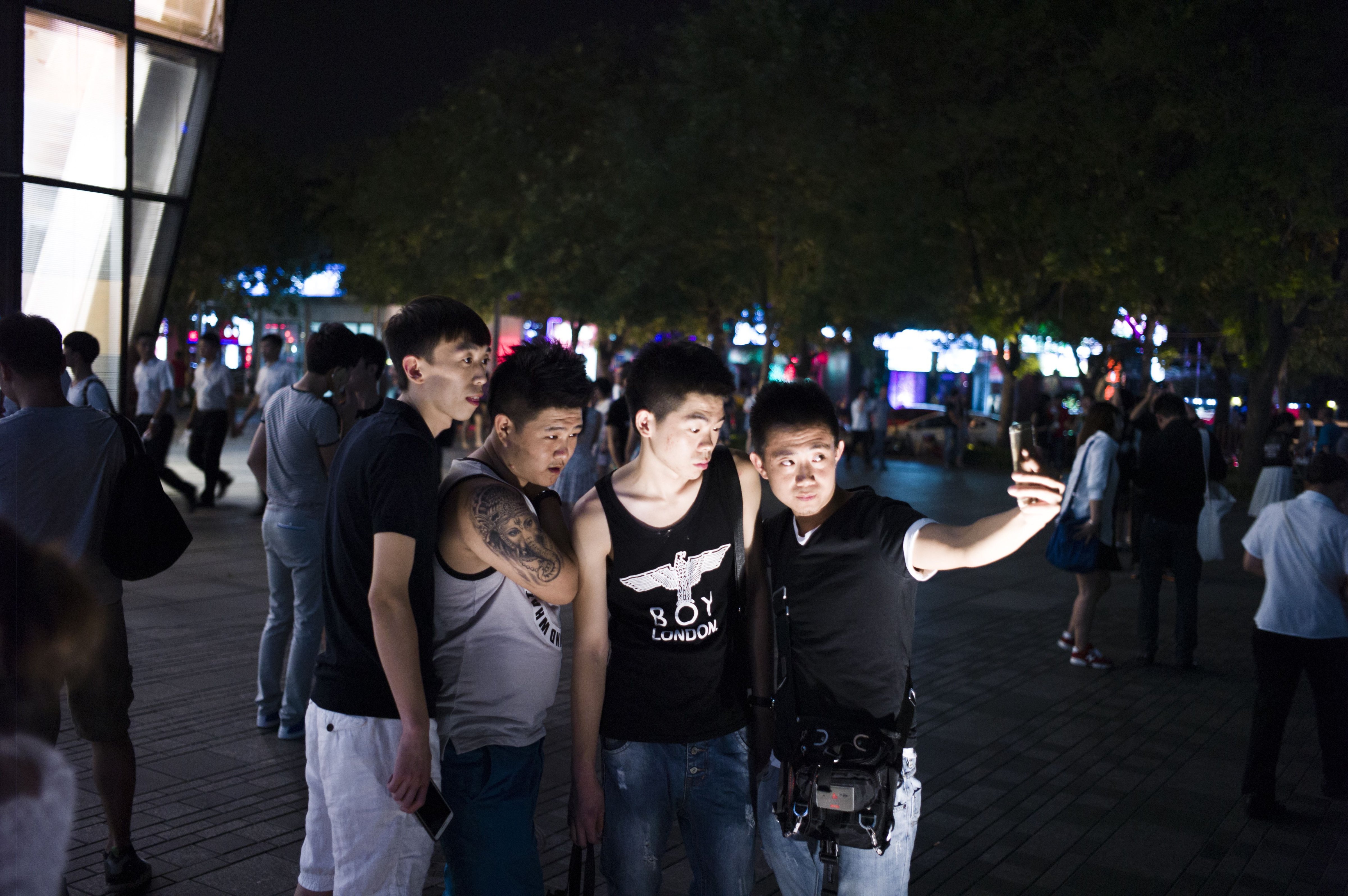 People gather in front of a Uniqlo clothes store in Beijing. (FRED DUFOUR&mdash;AFP/Getty Images)