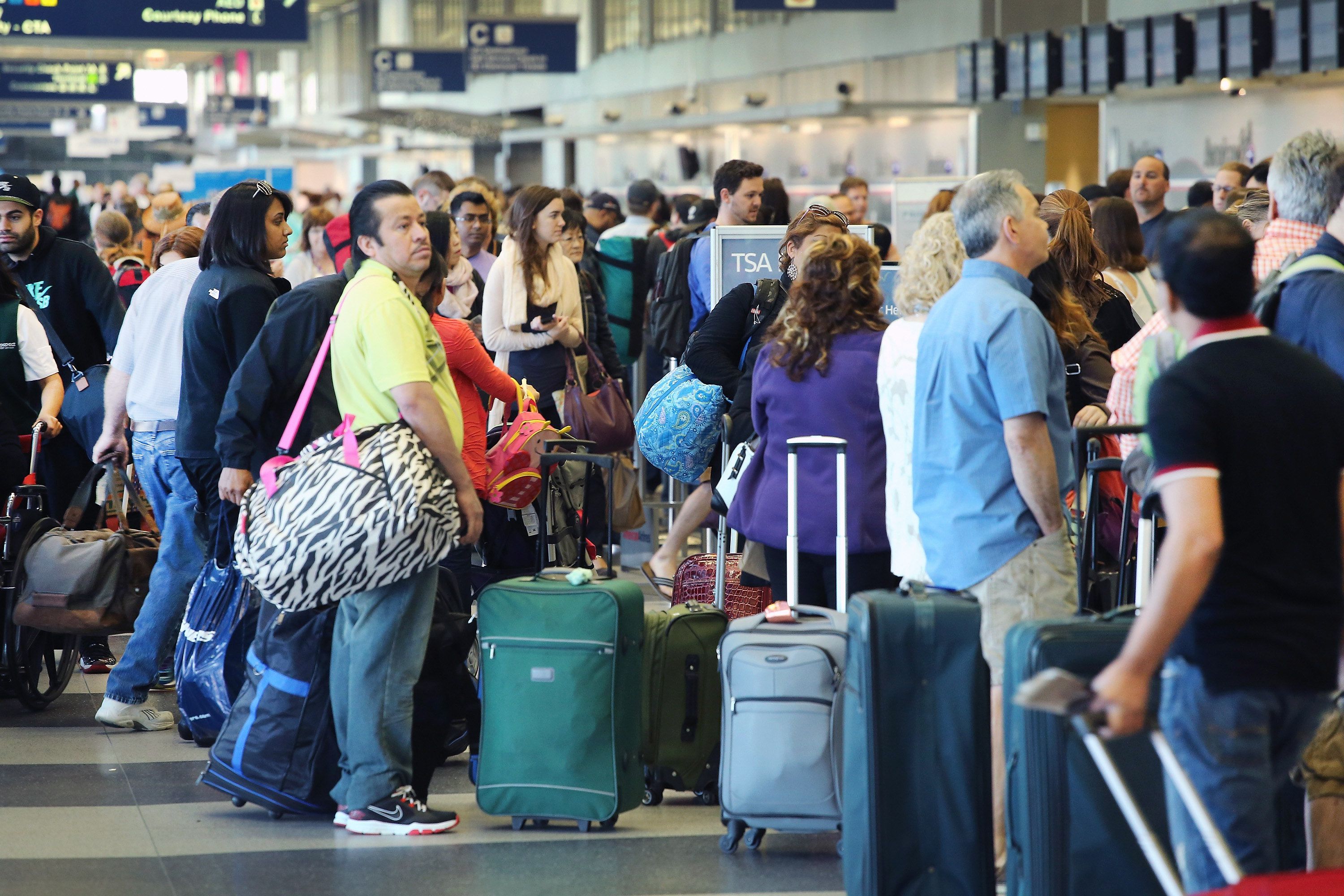 Passengers wait in line at a security checkpoint at O'Hare Airport in Chicago. (Scott Olson&mdash;Getty Images)