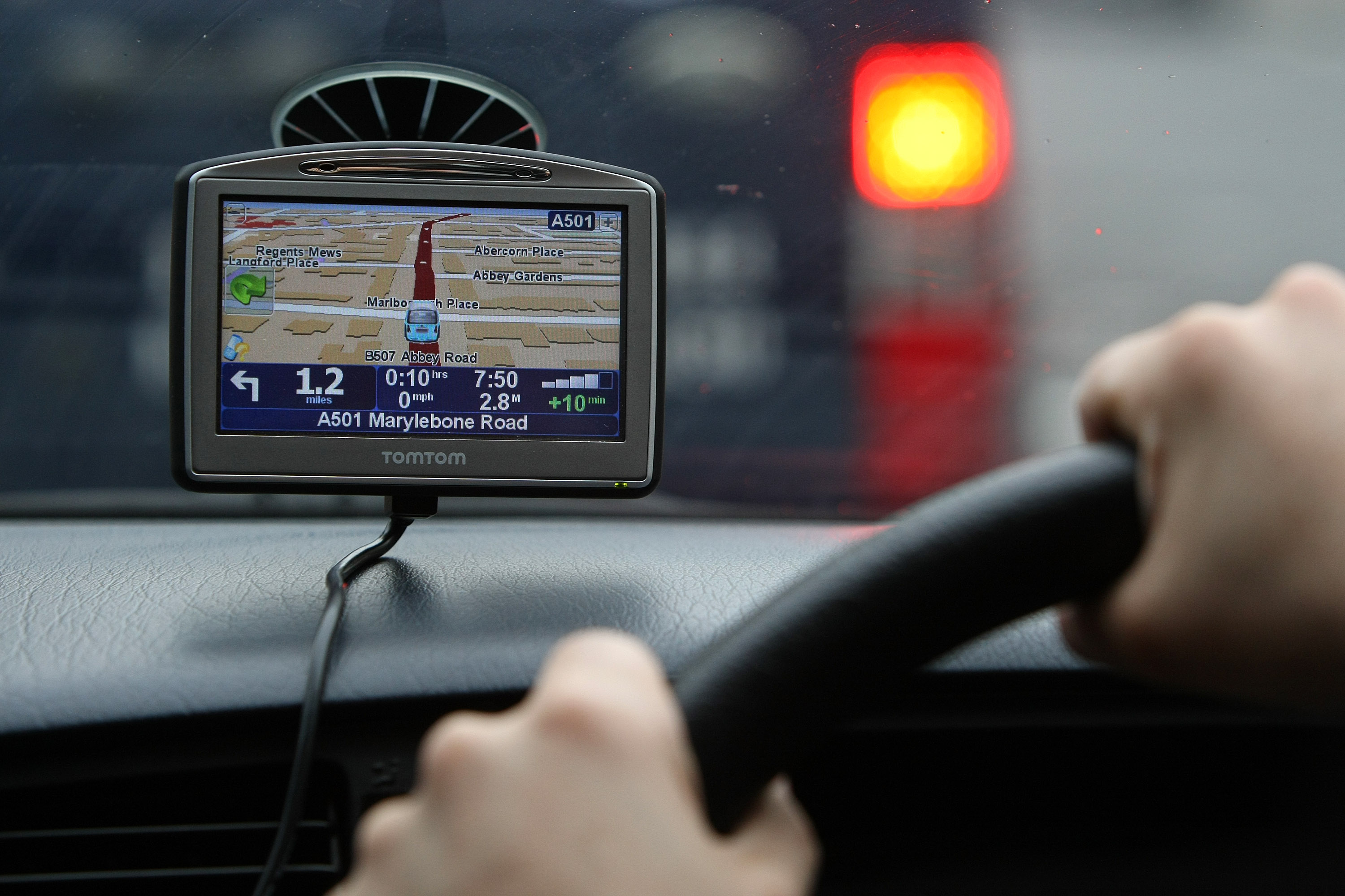 A driver uses a Tom Tom navigation device in central London,
