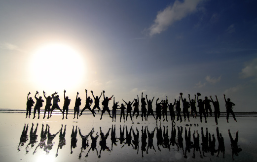 group-people-jumping-backlit