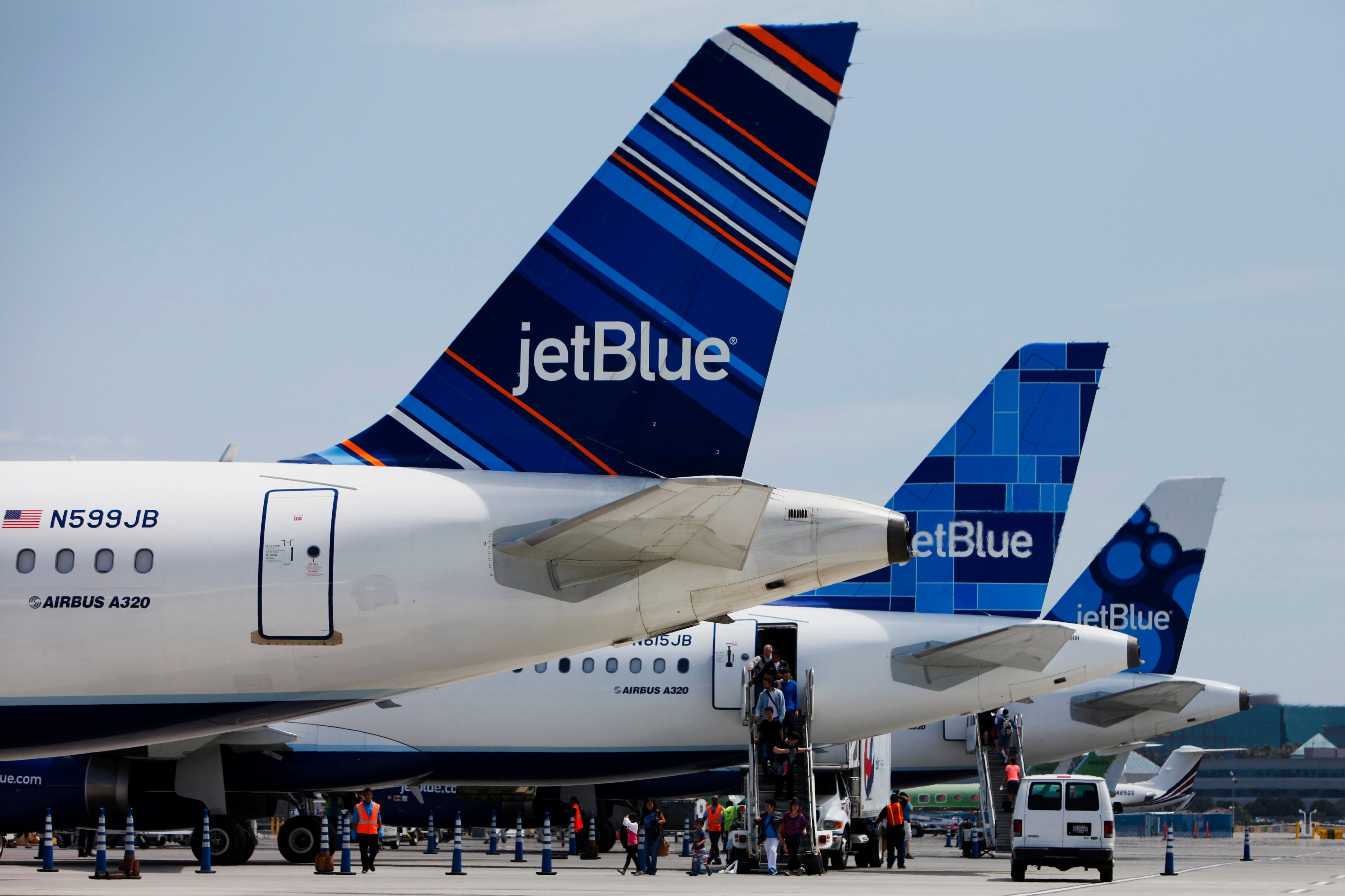 Passengers exit a JetBlue Airways Corp. plane at Long Beach Airport in Long Beach, Calif., on July 22, 2013. (Bloomberg via Getty Images)