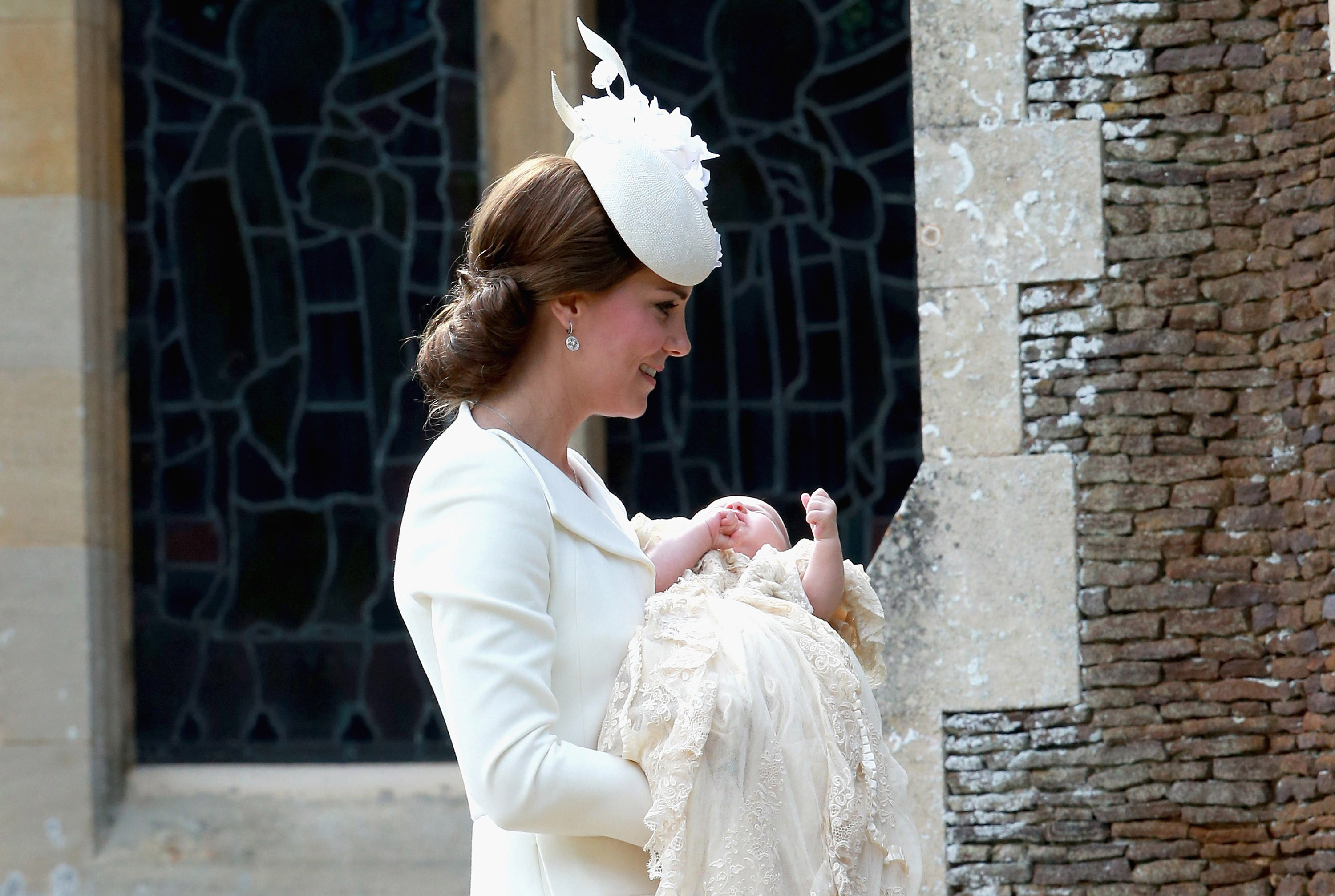 The Duchess of Cambridge carries Princess Charlotte as they arrive at the Church of St Mary Magdalene in Sandringham, England on July 5, 2015, as Princess Charlotte will be christened in front of the Queen and close family.