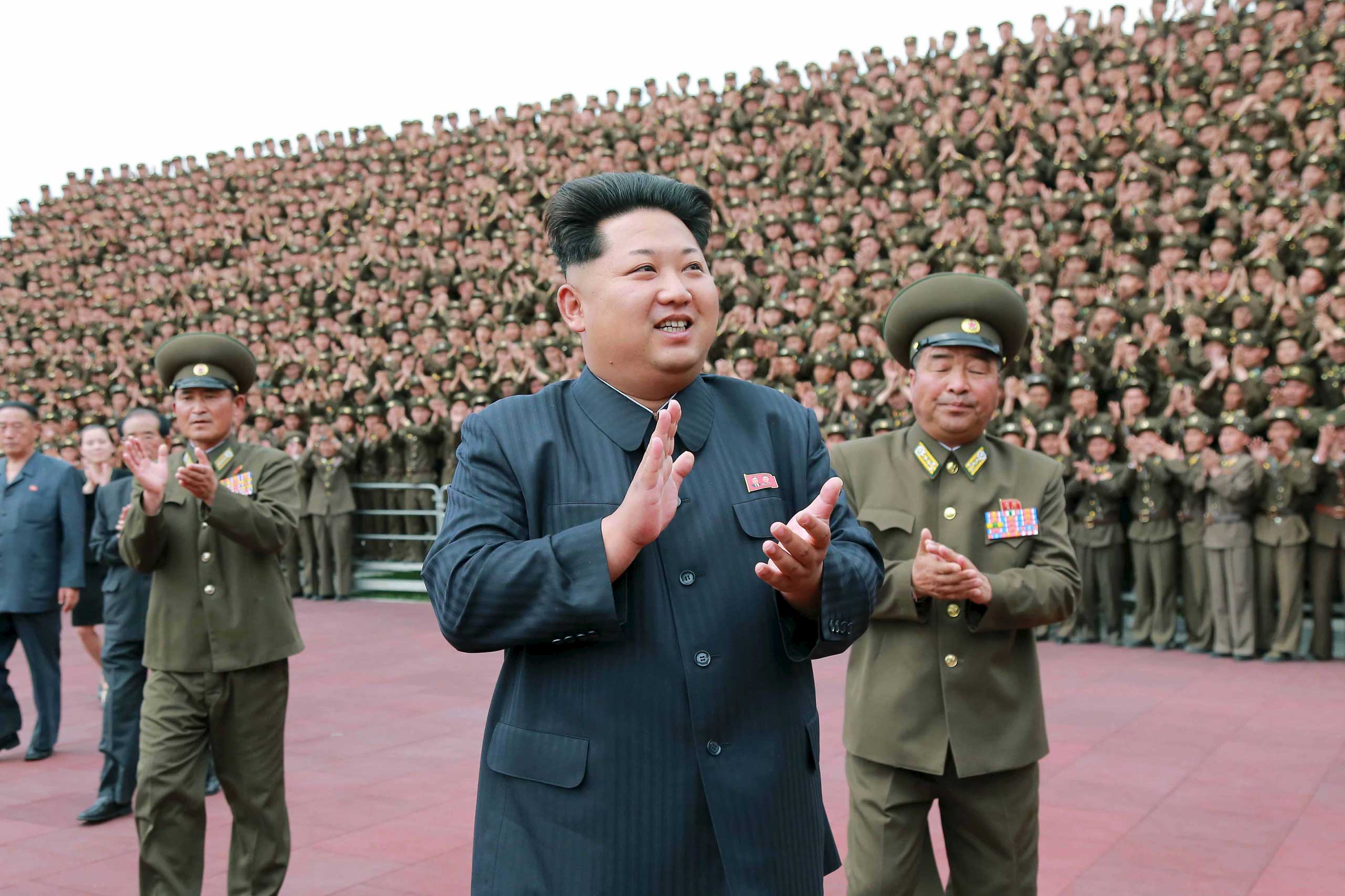 North Korean leader Kim Jong Un applauds during a photo session in Pyongyang (KCNA/Reuters)