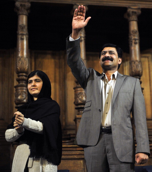 Malala Yousafzai and her father Ziauddin Yousafzai at the first Global Citizenship Commission in Scotland on Oct. 19, 2013. (Andy Buchanan—AFP/Getty Images)